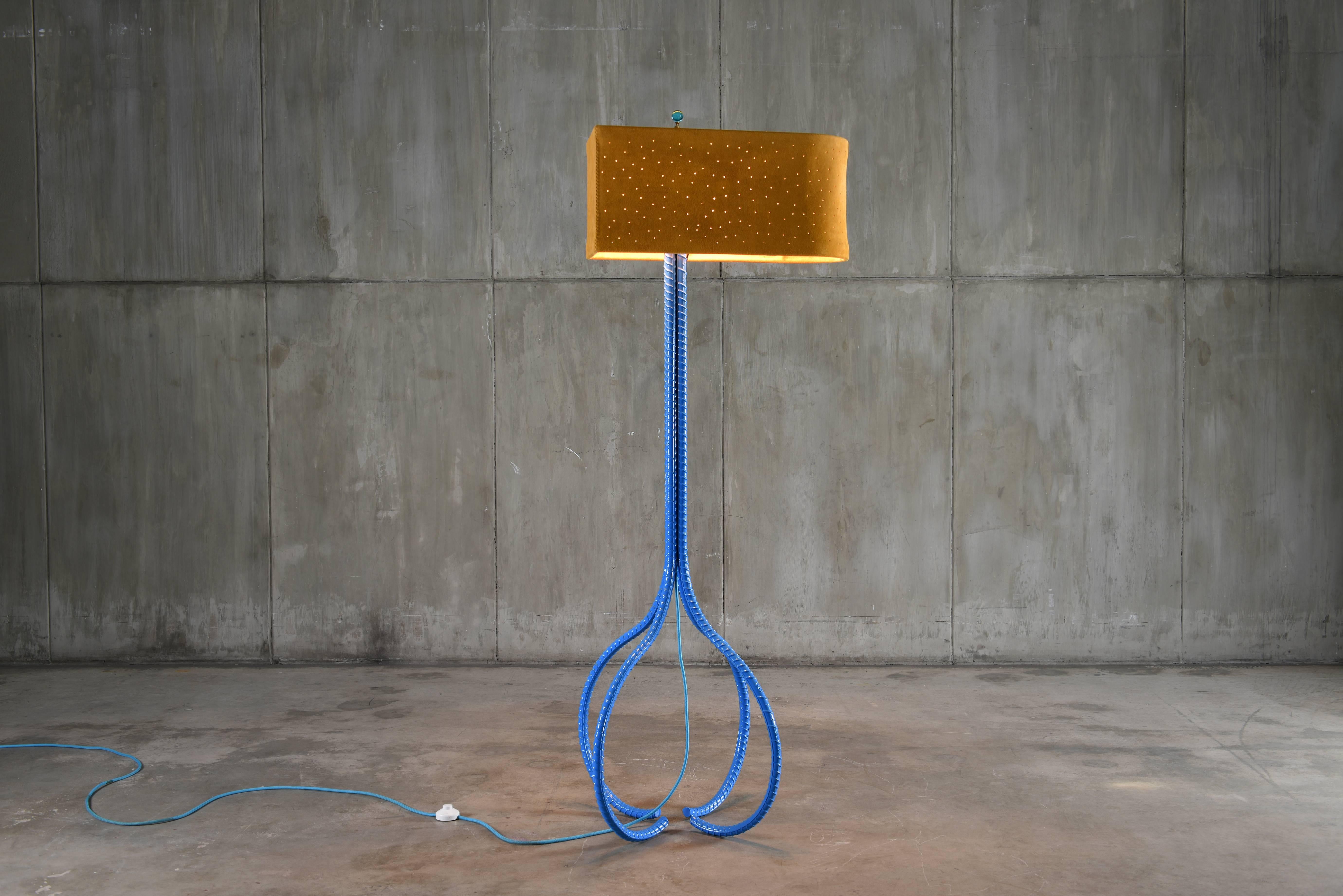 The Constellation Foor Lamp is part of the Rebar series created by artist Troy Smith. Rebar is the steel used in the forming of concrete to give it strength. The Rebar is heated with acetylene torches and red-hot furnaces, skillfully sculpted by