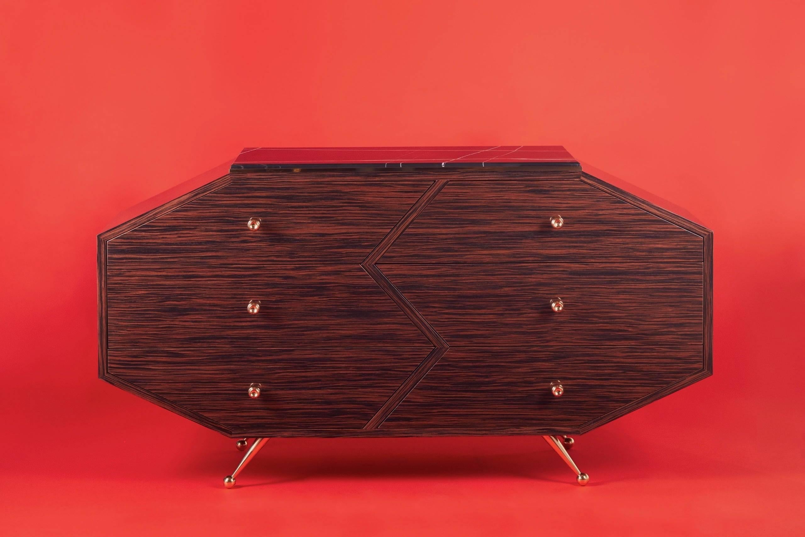 Contemporary and modern this Art Deco-inspired cabinet/dresser is custom-made by hand and designed by Troy Smith Studio. The Macassar Ebony is finished in a super high gloss finish which requires over 10 coats. All hardware including the feet and