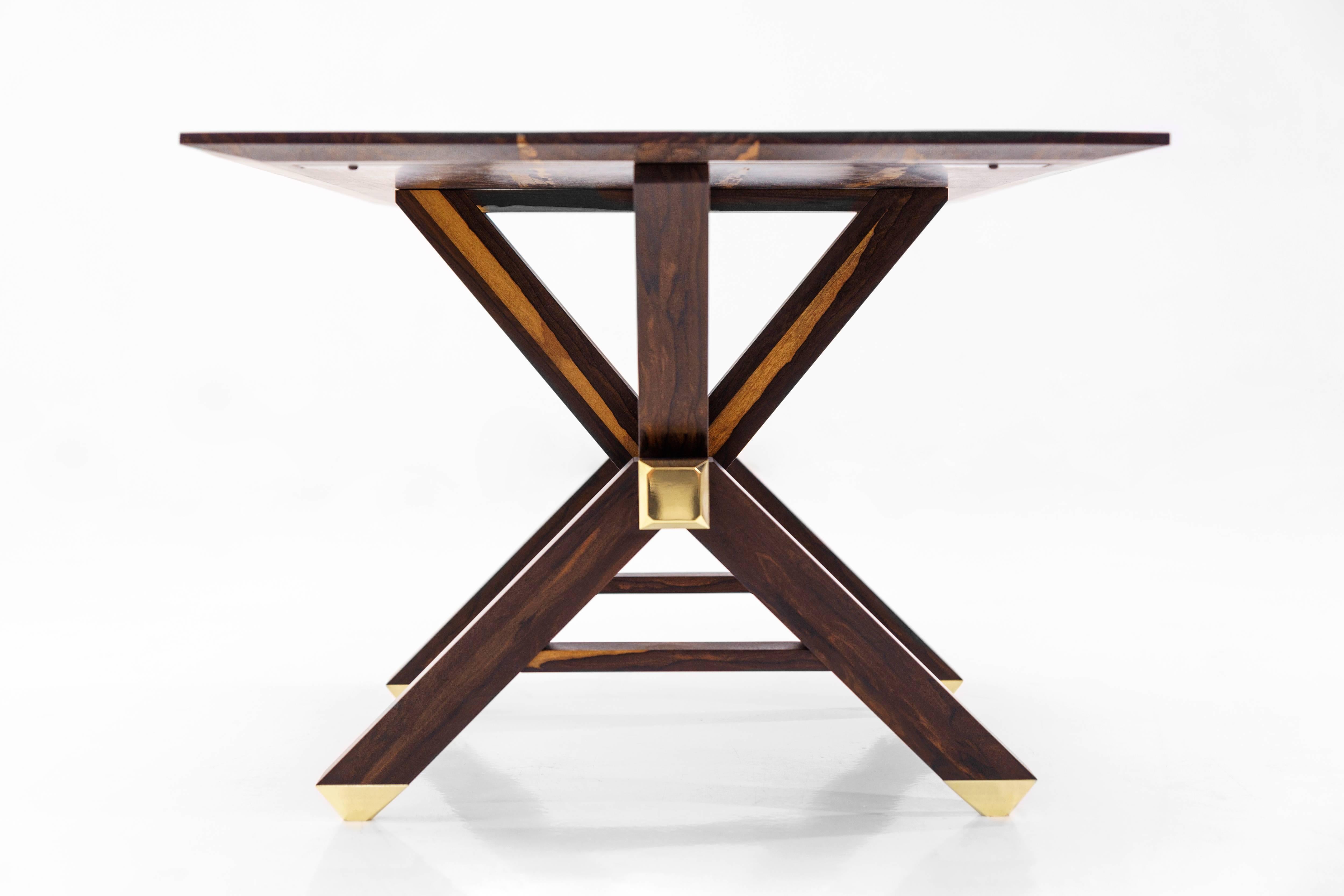 The Calypso table is completely handmade and was designed by Martin Goebel in 2017. Referencing the timber framing of wooden boatbuilding, the substructure yields uninhibited seating. Angular geometry is accented with billet machined brass shoes and