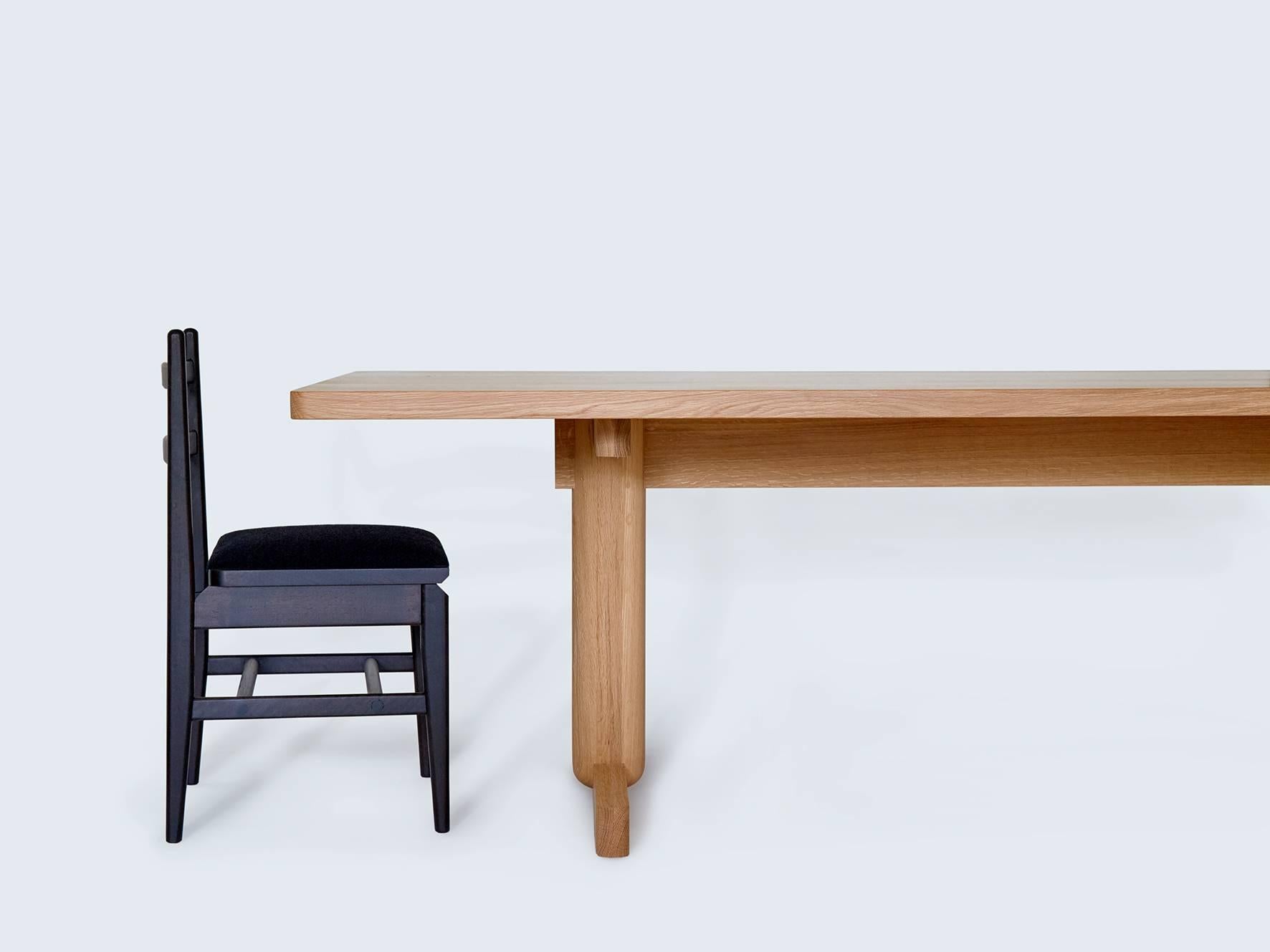 The Olmsted dining table is a contemporary trestle table that is handcrafted on a made-to-order basis. Influenced by simple Shaker tables, it features oversized turned legs.

It is available in Claro walnut, black walnut (natural, ebonized or