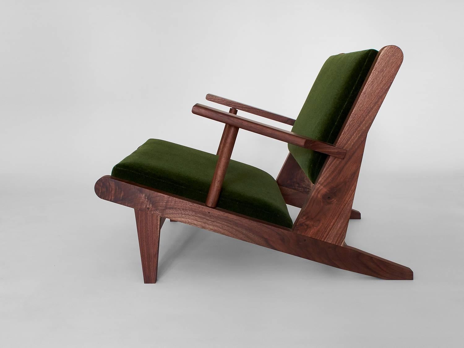 The hunting chair is inspired by Scandinavian furniture of the middle 20th century. It sits near the floor for an impactful statement around fireplaces and other living spaces. It is available in black walnut (natural, oxidized or ebonized), maple