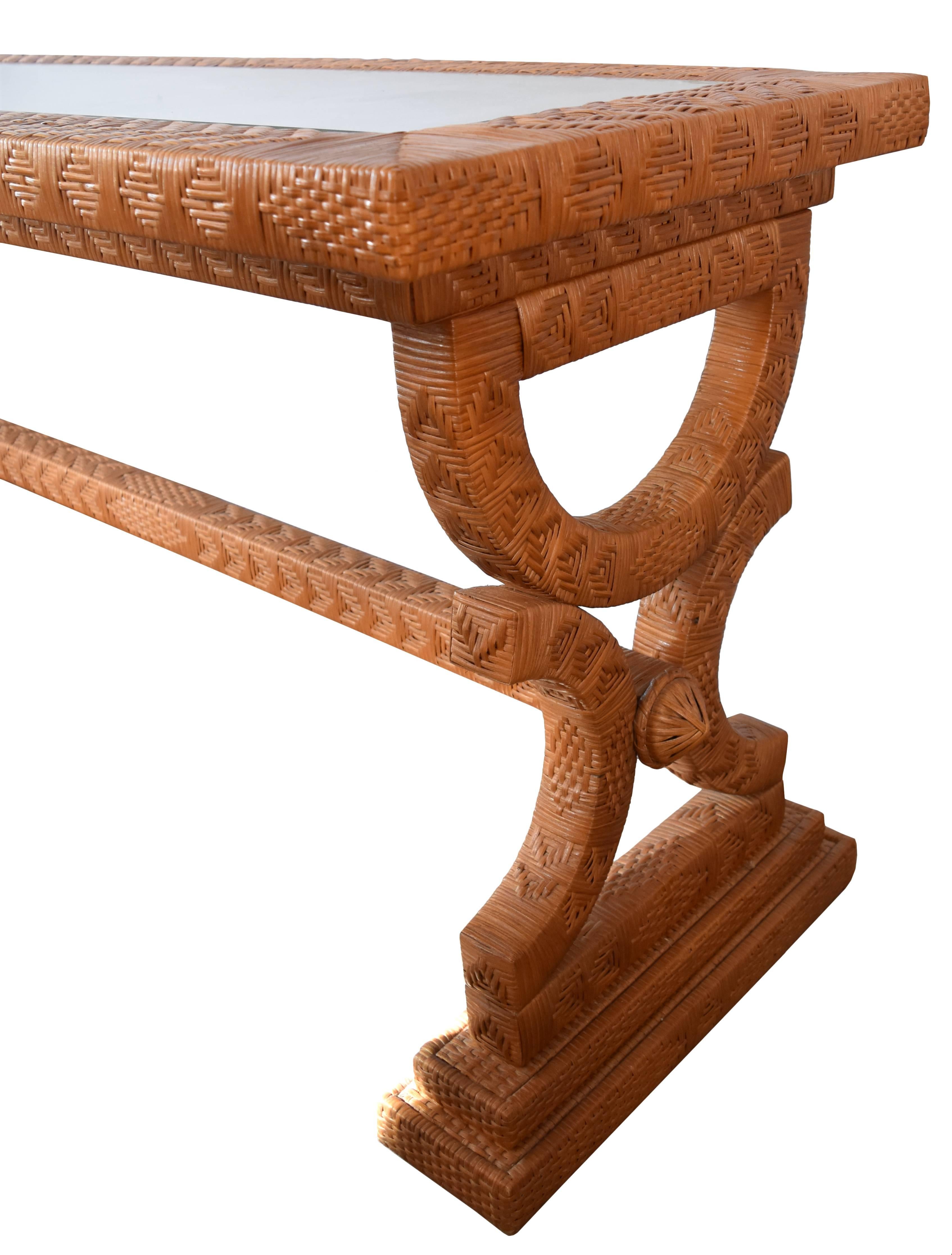 Classically styled joined table legs. Wooden structure under the intricately weaved rattan pattern. In pristine condition.
  
