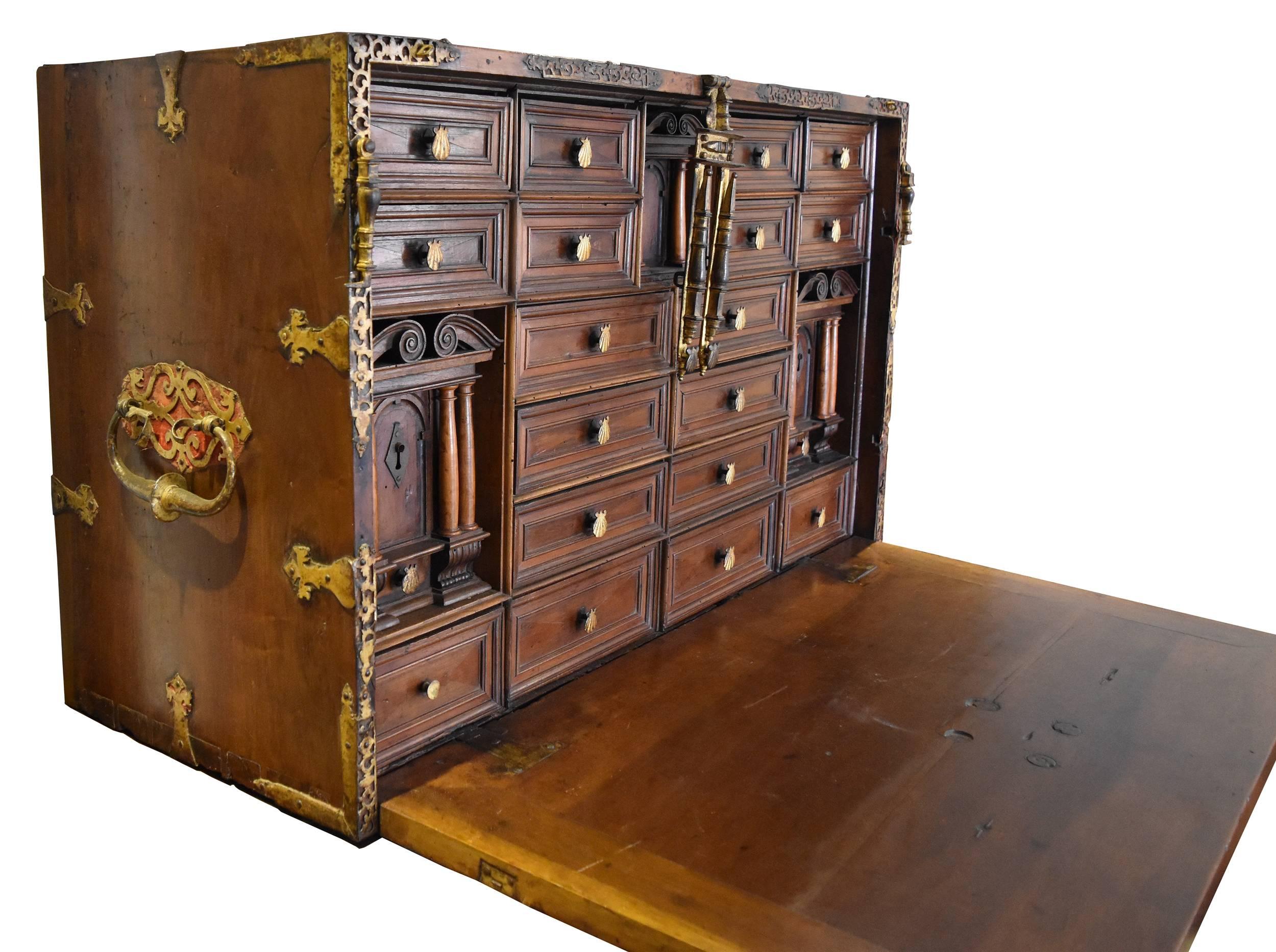 Original old gold iron handles and decorations covering exquisite velvet period cloth. Decorative columns in lemongrass wood. Designed for travelling, it opens into a writing desk and has four secret drawers. In pristine condition, it has not been
