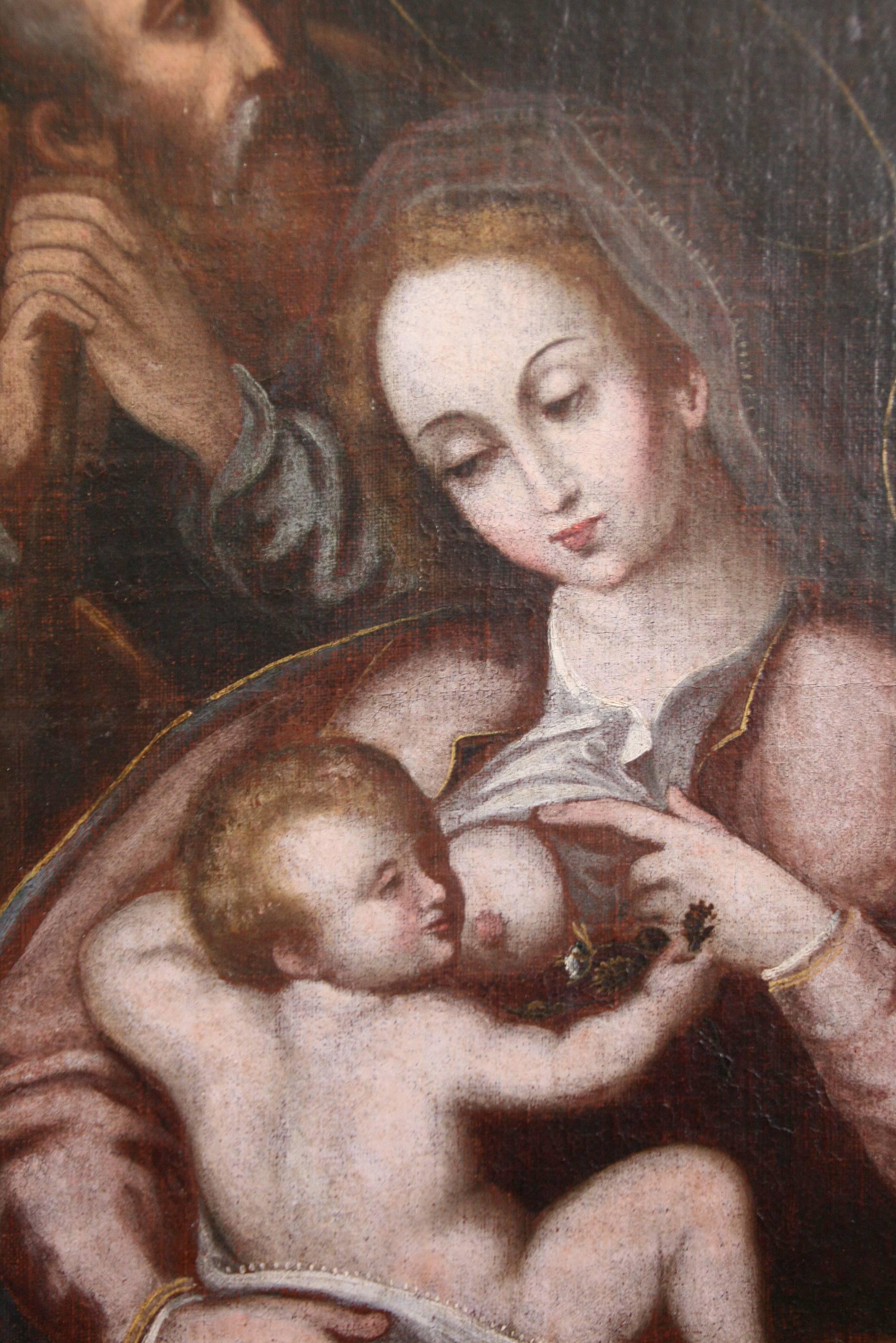 Beautiful oil on canvas with four protagonists, the Virgin breastfeeding baby Jesus with St. Joseph and a young St. John the Baptist. Typical 17th century composition with the secondary characters in the background. Relined canvas and original gold