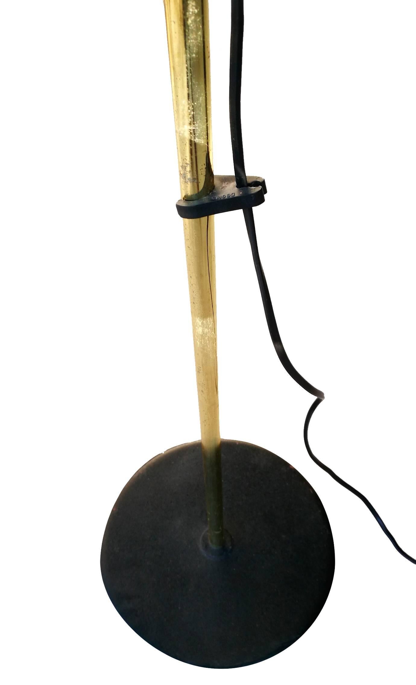 1980s standing lamp with a black iron base topped with a spherical acrylic dome.






