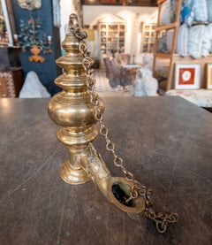 Antique Brass Oil Lamp with Chain and Decorative Snuffer.