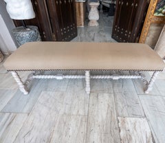 Antique Upholstered Bench with Turned Legs in a Stripped-wood Finish.
