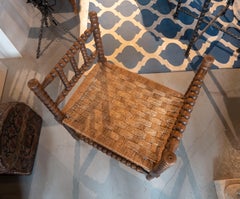 1970s Turned-wood Armchair with a Seat Woven from Natural Fibers.