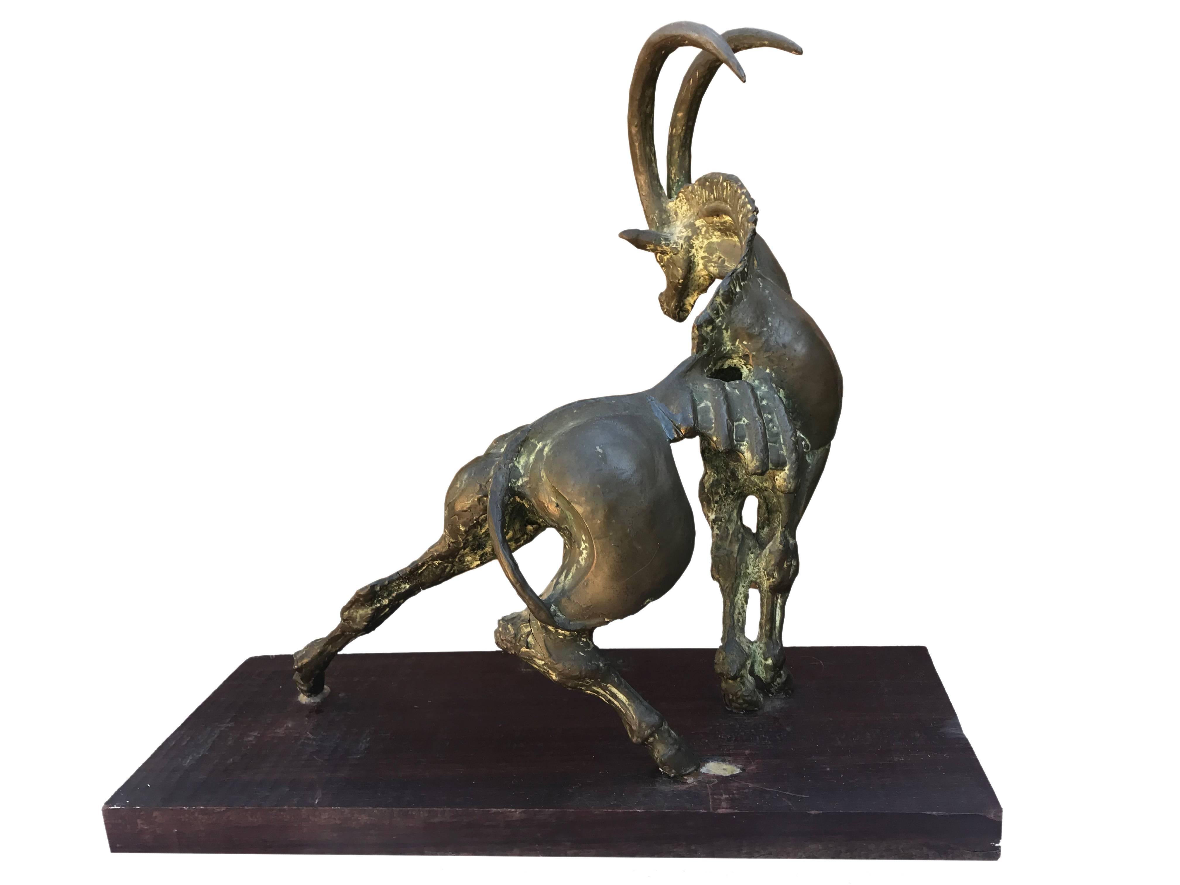 Abstract sculpture by Kurt Lossgott of a goat on a twisted stance with its proud horns held high.


 