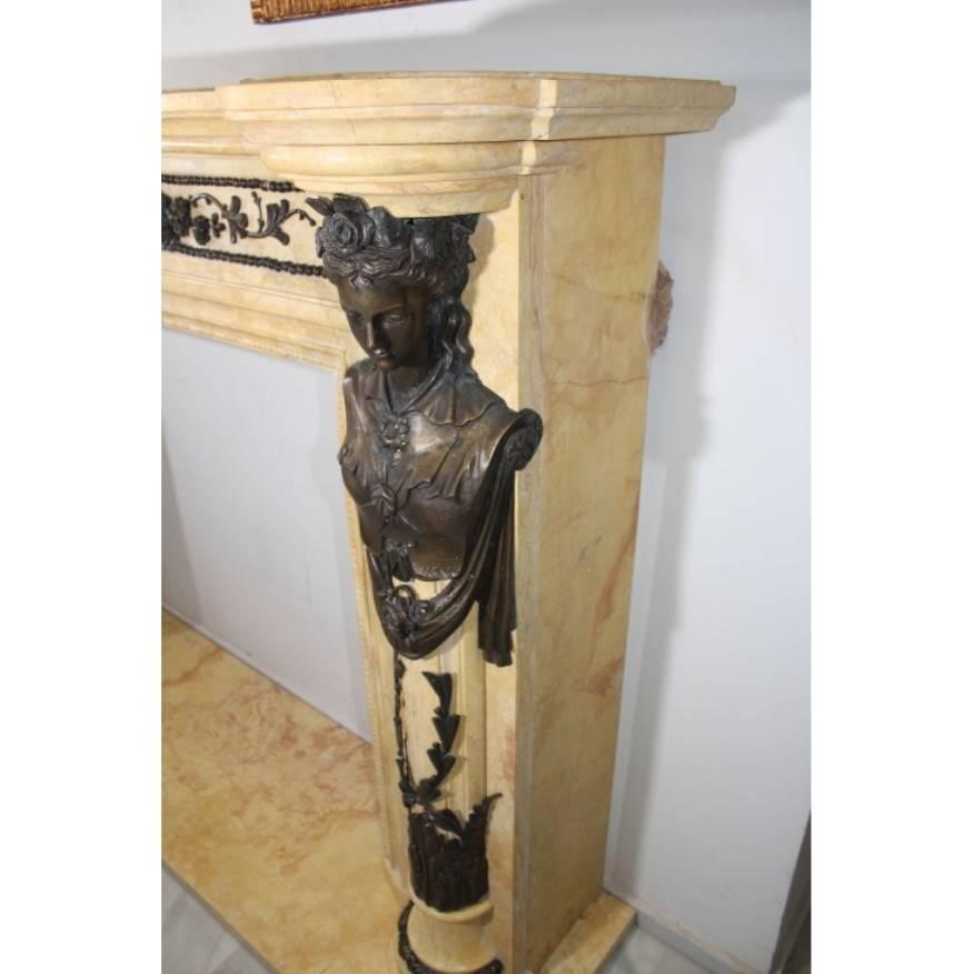 Hand carved Regency style fireplace with bronze caryatids and ornaments.
 