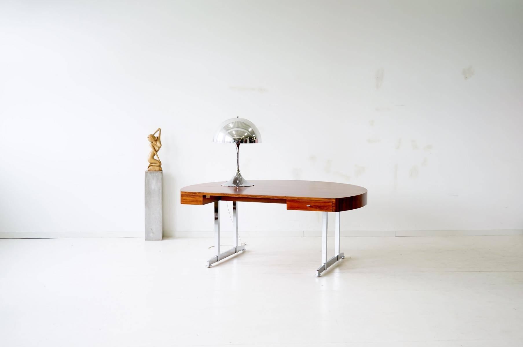 luxury executive desk table Scandinavian Modern, midcentury
Extremely rare, rounded desk. This high-quality desk is equipped with a drawer on the right. The large, rounded table is supported by two chrome-plated metal legs, creating an open look.