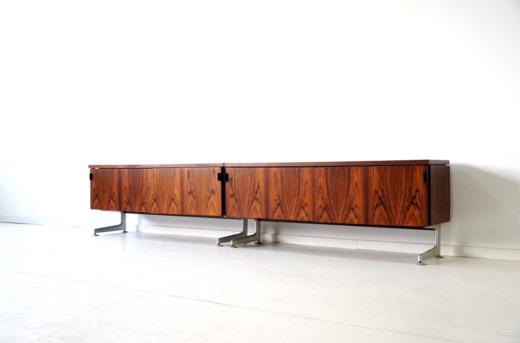 VOKO sideboard midcentury credenza diplomat
Very interesting designed sideboard with two sliding doors and leather holds. Lockable. Beautiful wood and light designed chrome base. The elegant sideboards are very high-quality processed. They are from