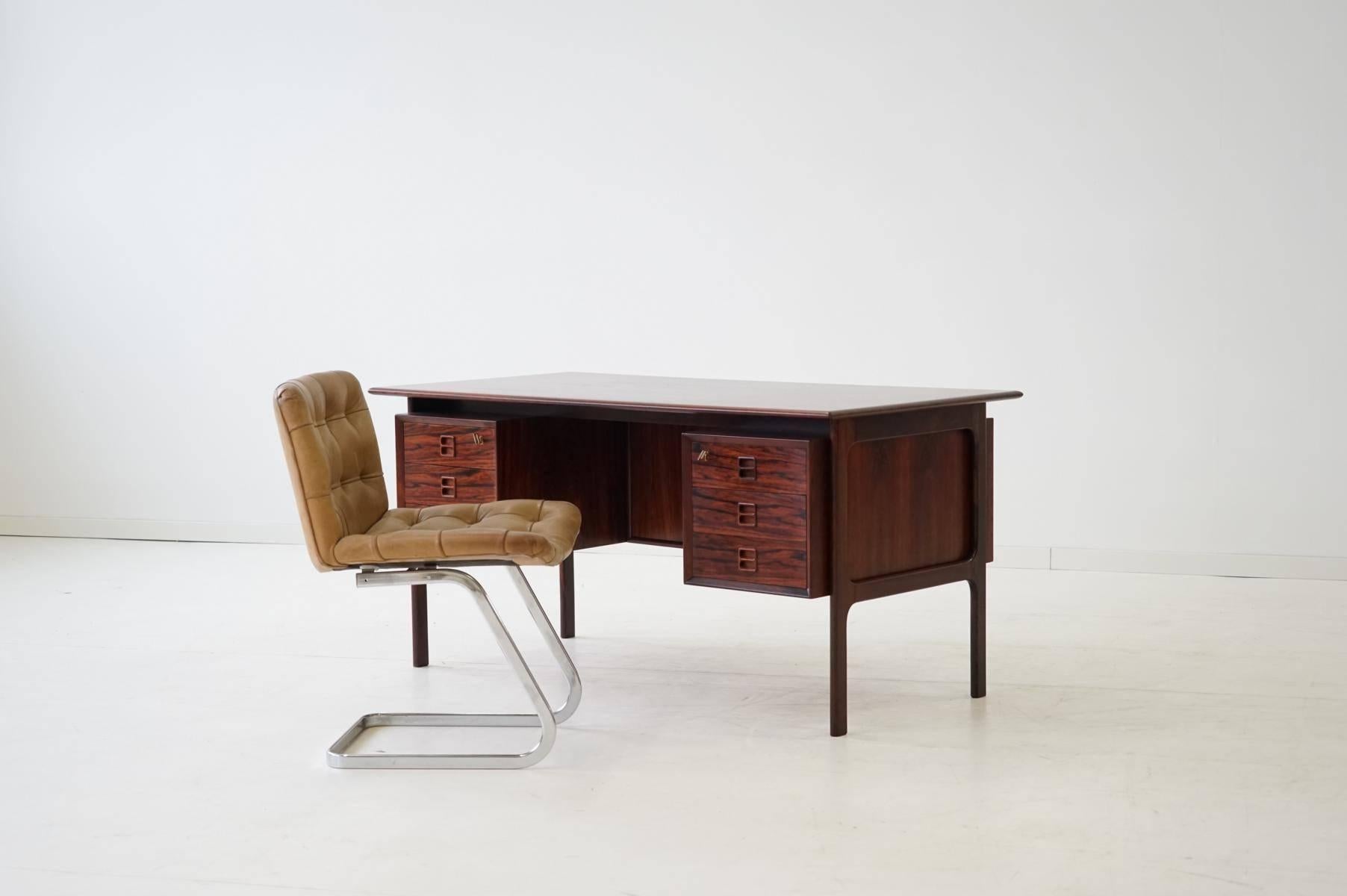 Arne Vodder for Sibast Palisander desk
This midcentury desk is very handy. Lockable drawers on the front and shelves on the back of the desk, give space for documents, books etc. 
Excellent workmanship and with very nice grip.