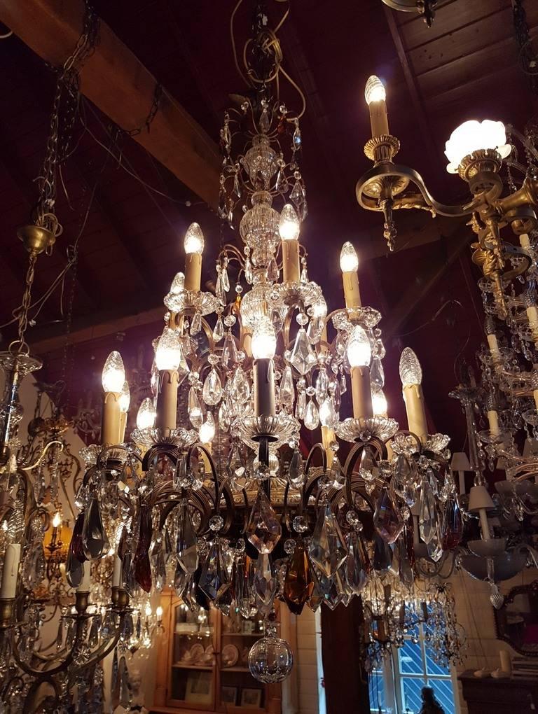 Large chandelier with colored crystals like purple and amber. Beautiful glass in the centre.

This is just one of our large collection chandeliers. Besides the old and antique chandeliers we have beautiful series of new large chandeliers in the