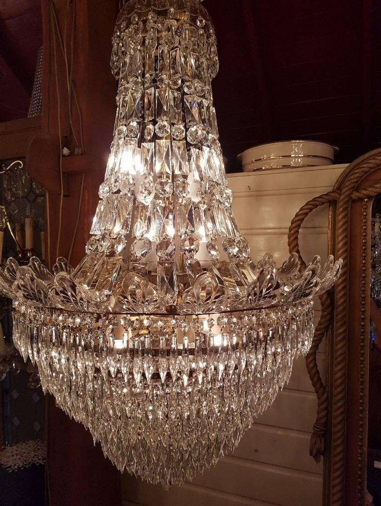 This large crystal bag chandelier has a waterfall of ten layers of crystals at the bottom. The top of the chandelier and the ring in the middle is nicely decorated with glass ornaments.
This is just one of the collection of 1000 chandeliers,