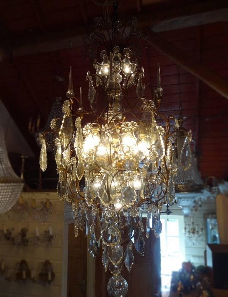 Set of two French cage chandeliers with 16 lights each and 6 pinnacles and crystals partly in fume color. Completely restored and rewired.
This is just one of the collection of 1000 chandeliers, ceiling lamps and wall lightning. Our collection is