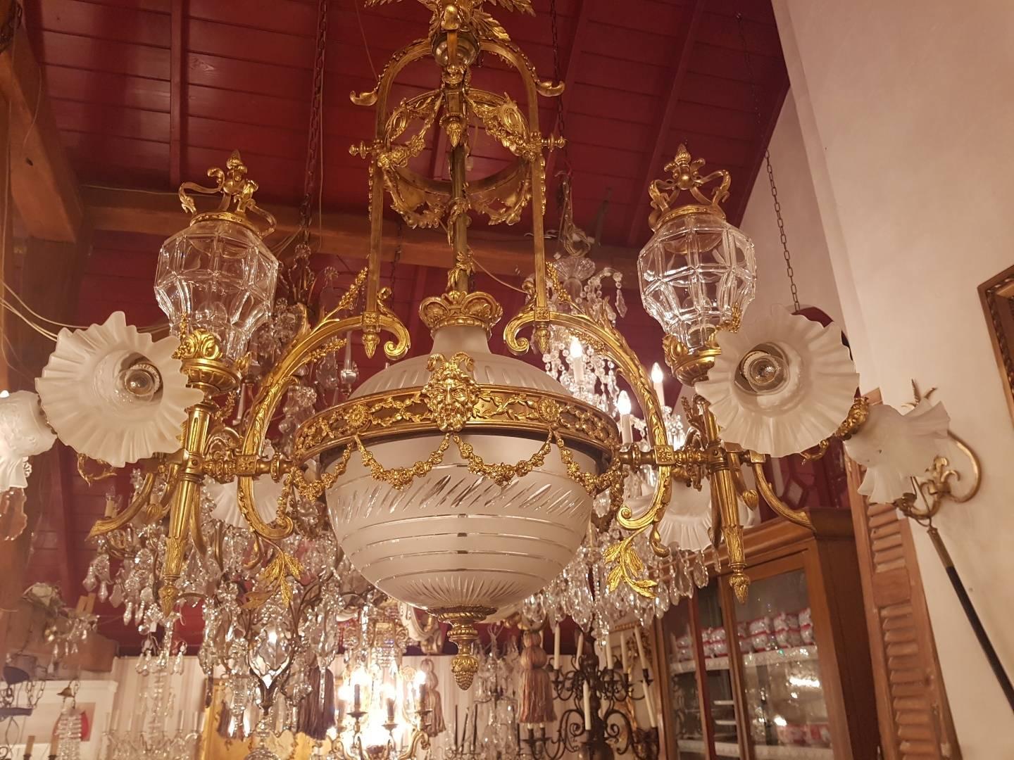 Large Empire Style bronze chandelier with two large lanterns with beveled glass, Beautiful ornaments like guirlandes and a globe from Victorian cut-glass with a diameter from 35 cm. unique piece.

This is just one of the collection of 1000
