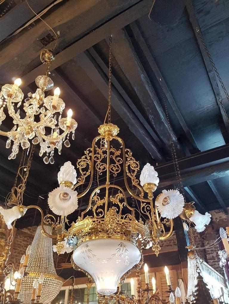 French chandelier with a coupe of Venetian cut-glass at the bottom and two frosted glass flames at the top and six glass shades.
This is just one of the collection of 1000 chandeliers, ceiling lamps and wall lightning.
 