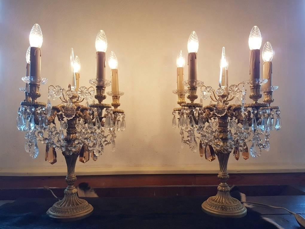 Two bronze Spanish chandeliers from a great quality with five lights and one pinnacle. Both pieces hung with beautiful crystals.
This is just one of the collection of 1000 chandeliers, ceiling lamps and wall lightning.