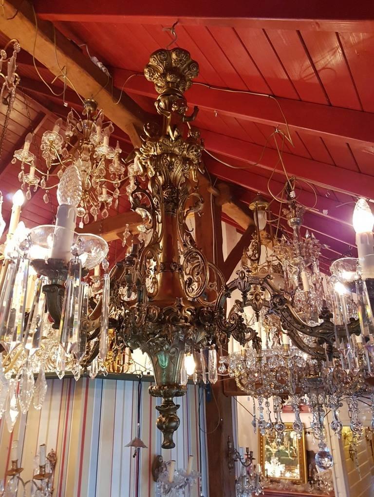 Bronze chandelier with beautiful ornamental detailing and three angels in the top. Six lights.
 