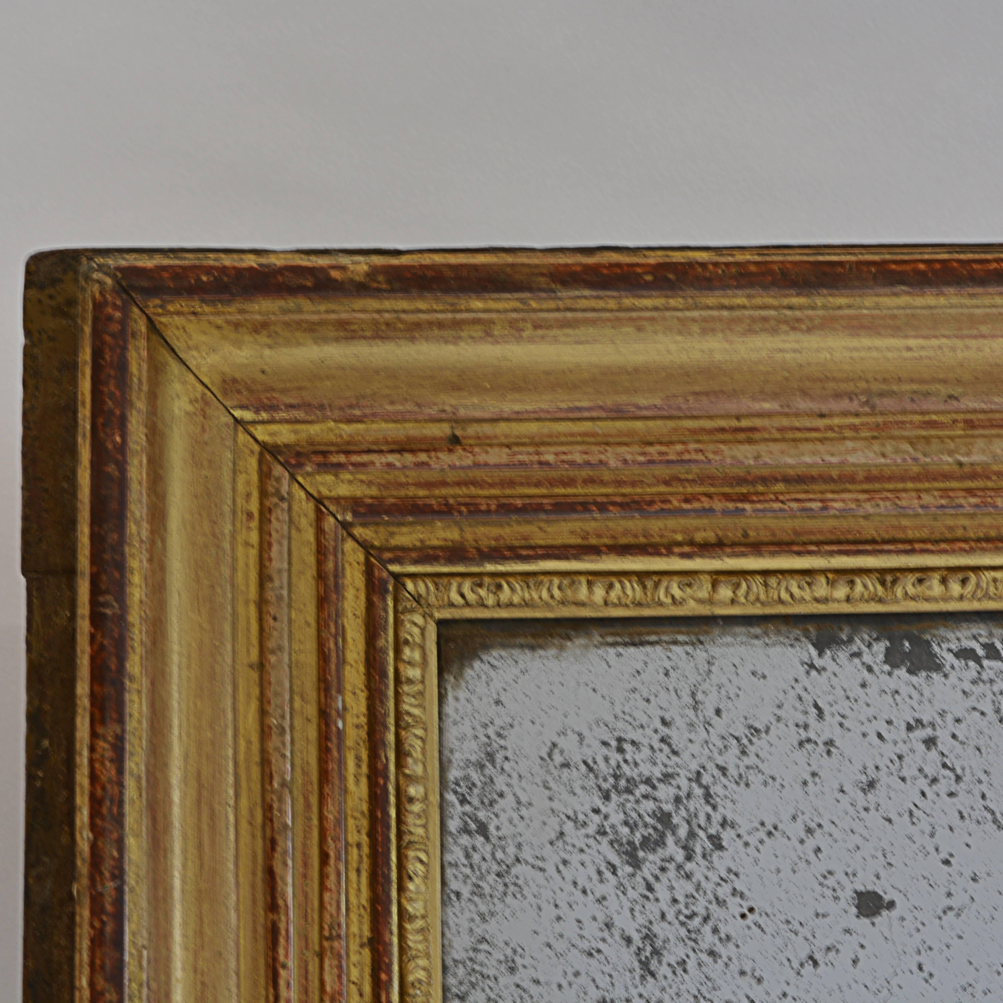 This might have been an unassuming hallway mirror in an upscale home when it was new, back around 1860. Today, though, it's a poignant link to a time long past. We find it especially desirable due to the condition of its gold-painted wooden frame
