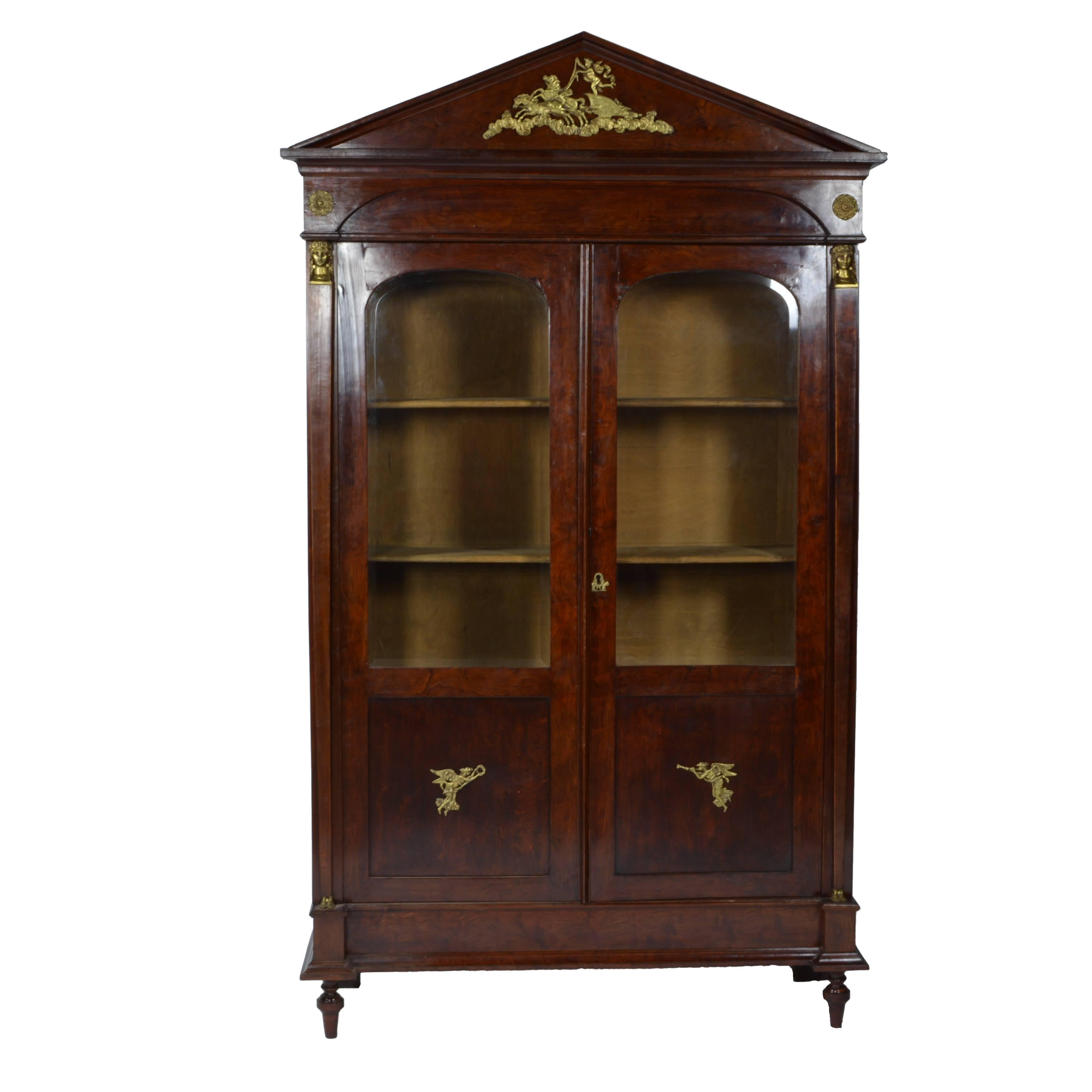 Imposing elegance for the estate office. Rare to find such a quality matched pair of bookcases from France with twin glass-front bookcases from the Napoleonic Era, circa 1815. The dark, rich finish and classical-themed gilt ornaments are perfect