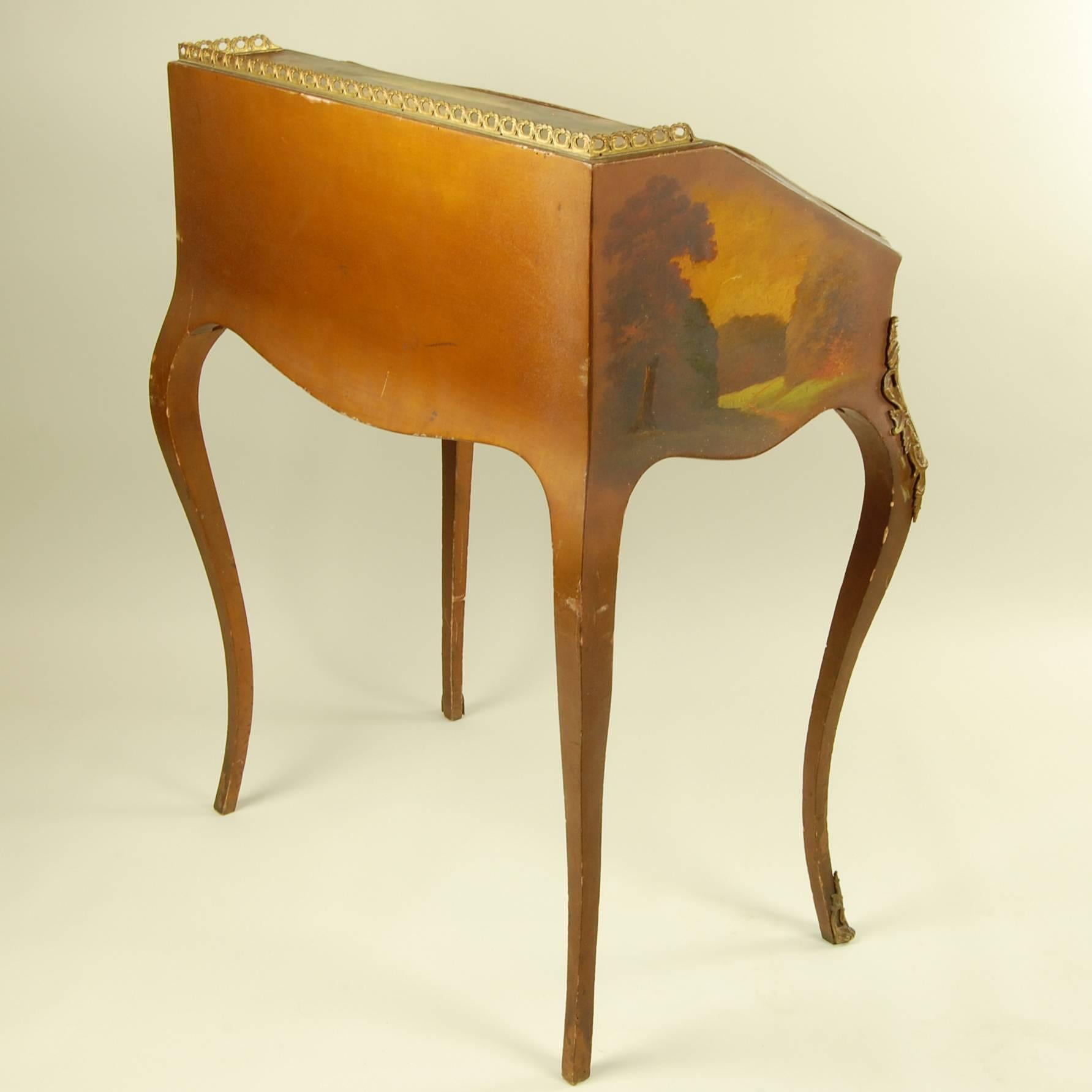 Country charm abounds in this sprightly writing desk dating from about 1880. Lavishly hand-painted, it displays several pastoral landscapes surrounding a pair of lovers in the woods. Graceful curved legs with gilded bronze knees support the desktop,
