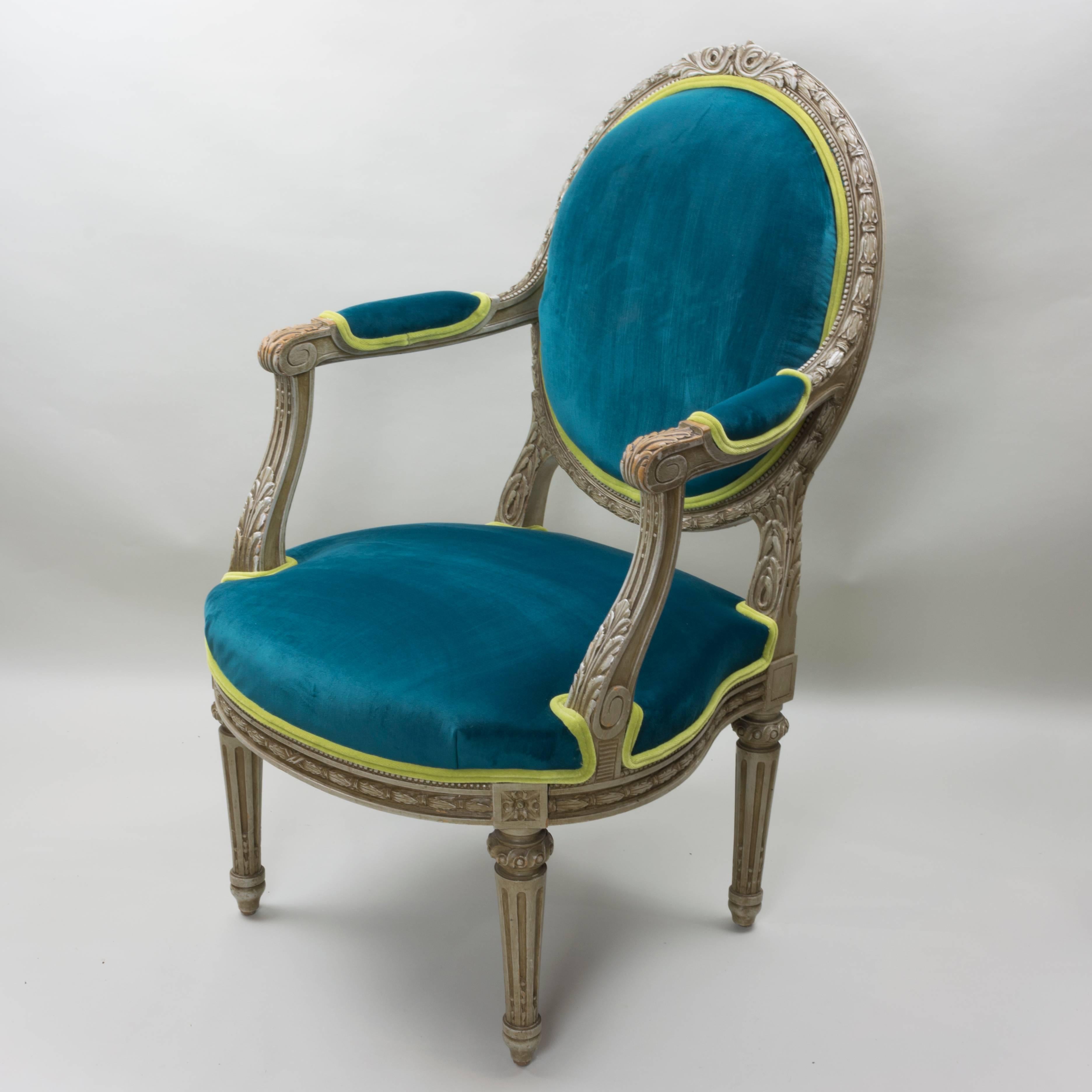 This pair of Louis XVI style armchairs have been recently updated in a lush blue-pine velvet and a coordinating lively lime velvet. These chairs were meant to make a statement. Now with the updated upholstery and the original design details, they