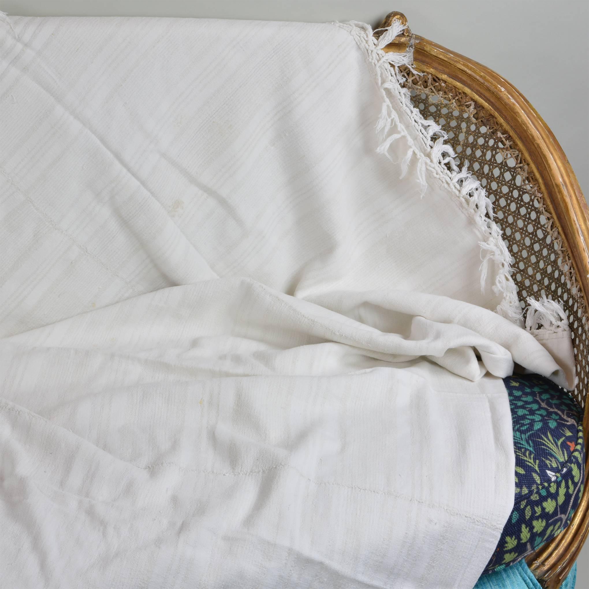 Super soft handwoven fabric was designed at the time as a bedspread.  It is lightweight and subtle cream color.  It was made on a smaller loom than the commercials ones used today.  As such, three pieces of fabric are woven together to get the