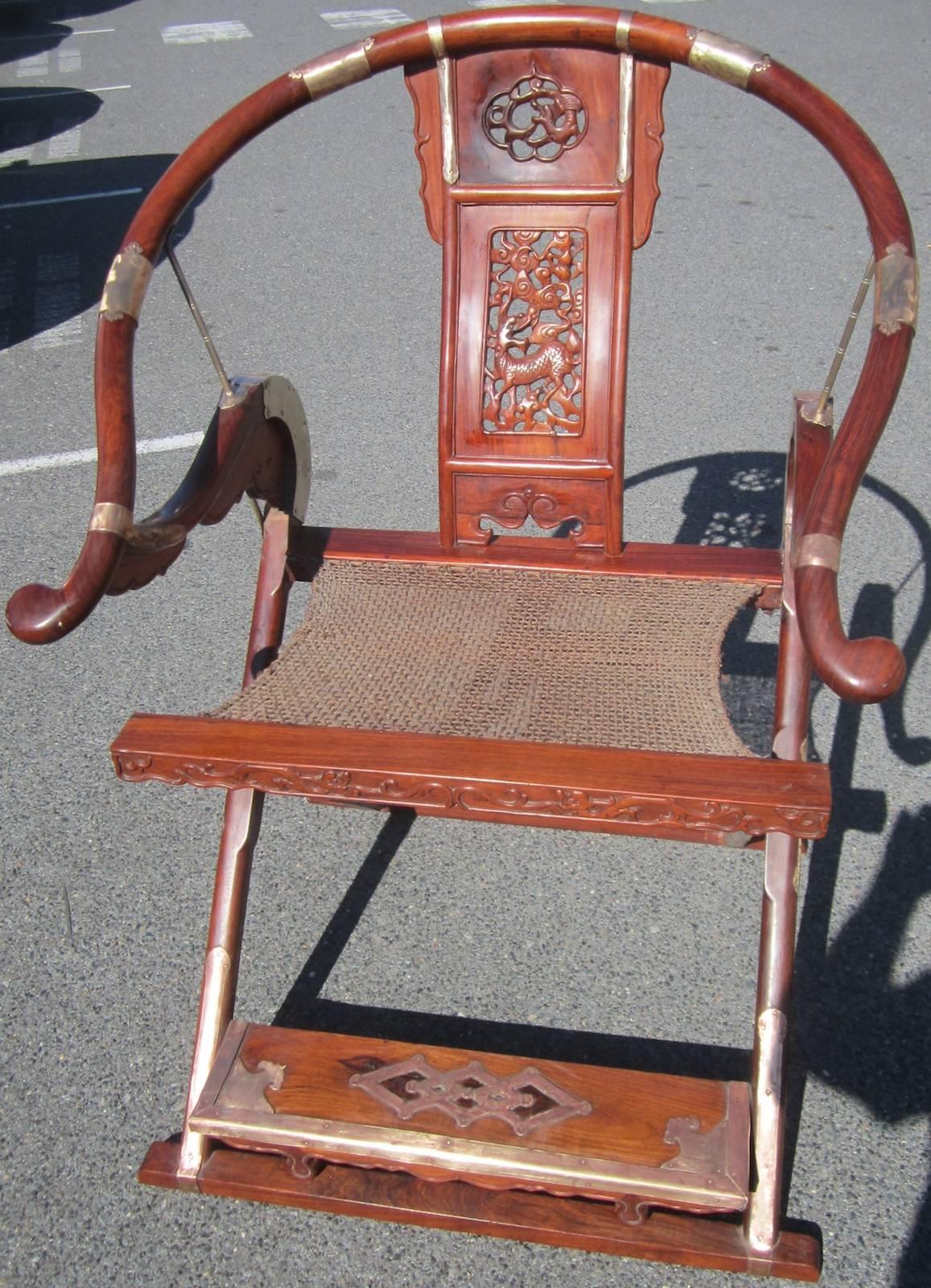 Chinese folding hunting chair,
tulip wood with brass and copper binding,
ex Macau casino,
Measures: 77 x 60 x 108cm high.
