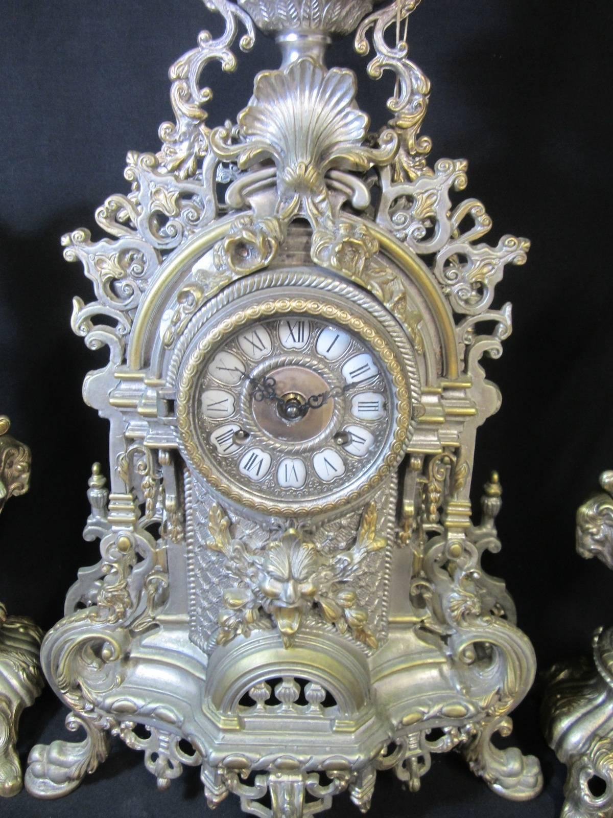 Italian three-piece brass garniture clock set with a German balance movement.
Chimes on the hour and half hour.
circa 1975,
Measures: Clock is 60cm high,
Garnitures are 43cm high
Three-piece set weighs 26kg.