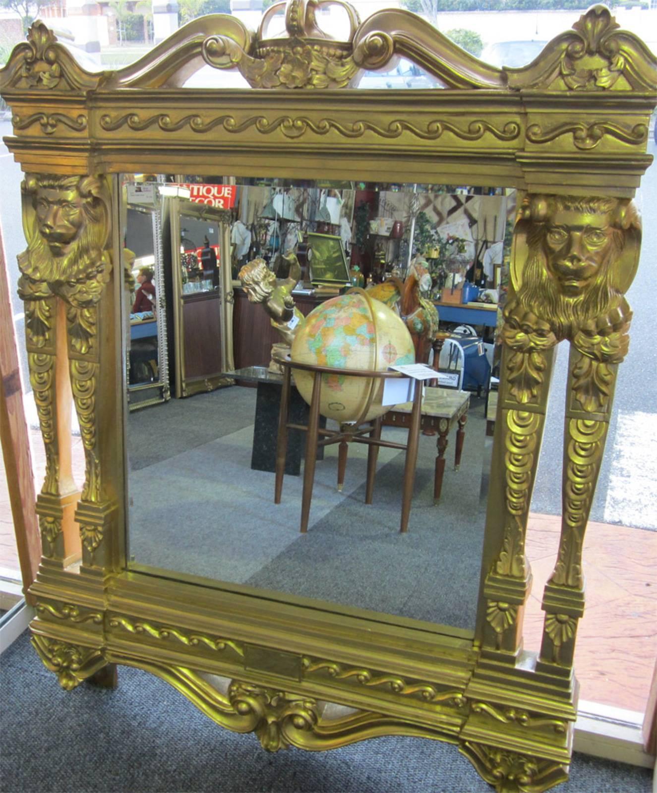 French style, gold color, bevel glass mirror, 
with intricate carved wood lion and crown decoration. 
115 x 143 x 12cm. 
Weighs around 50kg.