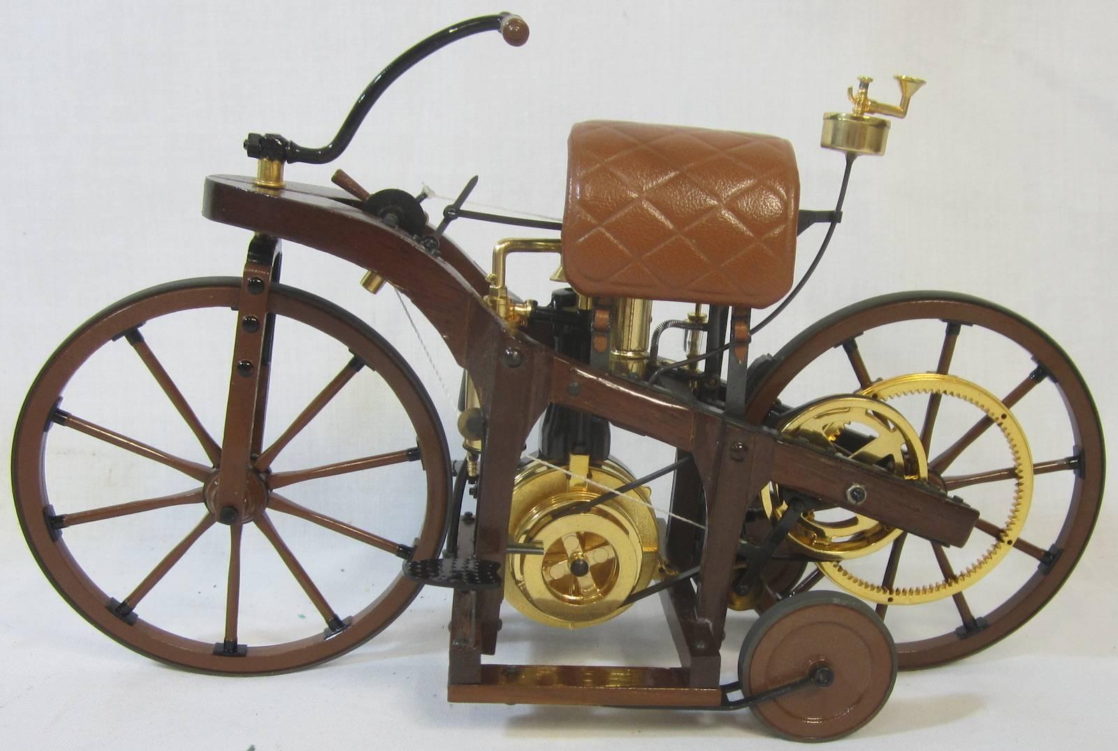 Highly detailed, replica veteran steam powered motor cycle in a glass display cabinet, motor cycle measures approximately 20cm long, 
cabinet 42 x 29 x 27cm high.