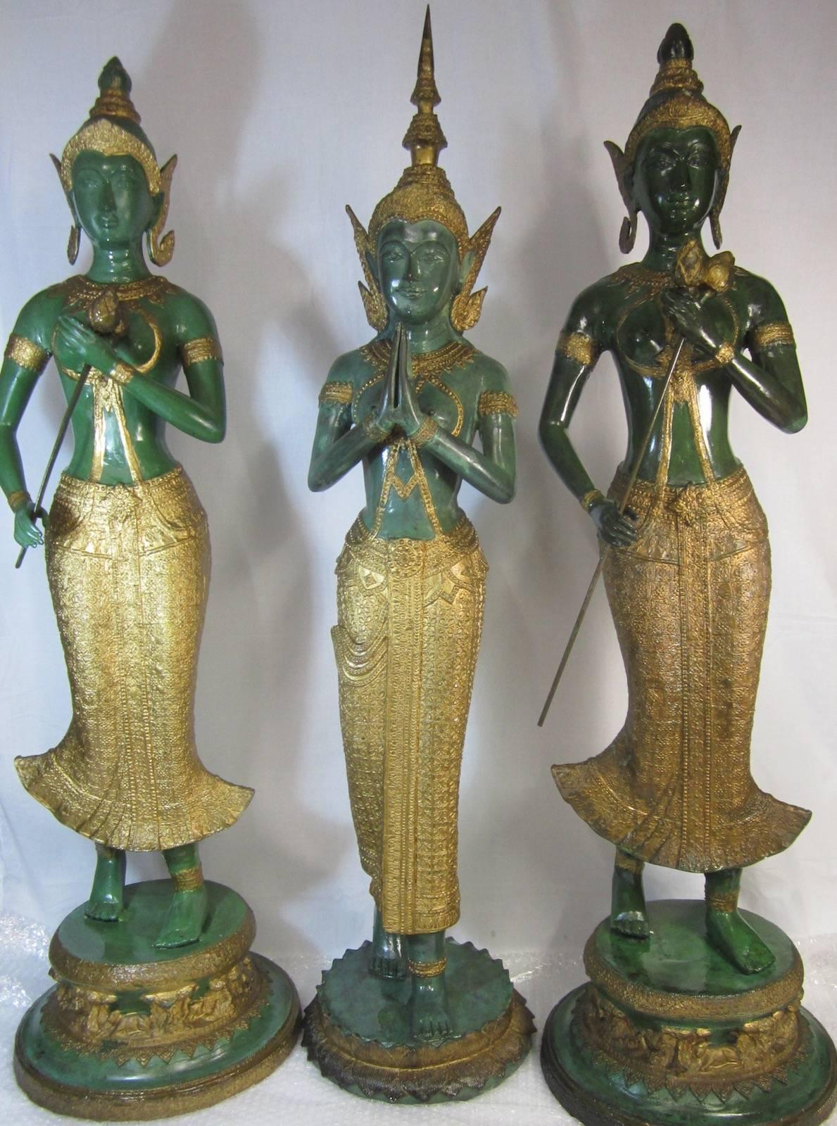 Three x Thai gilt decorated bronze statues,
total weight 57kg,
Measures: 28 x 115cm high.