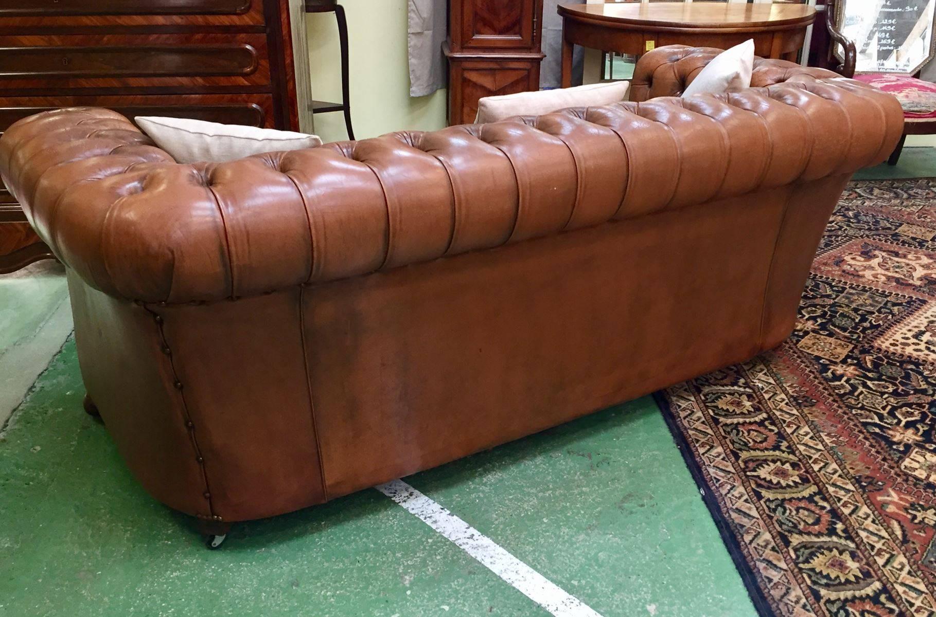 Lovely Chesterfield sofa in leather and tissu. The fabric seat and the three coussins is new.