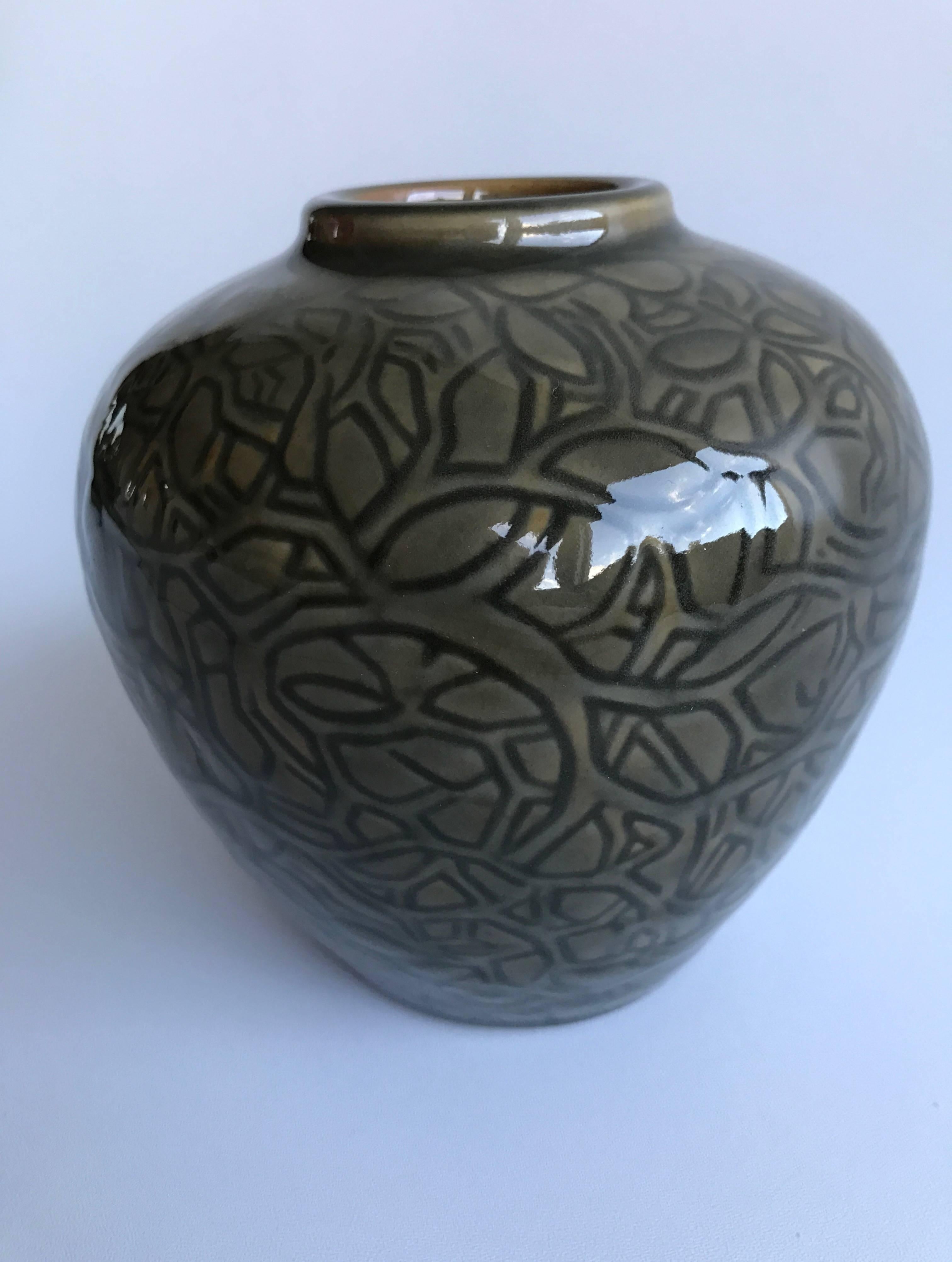 Beautiful Axel Salto vase in green and black glaze with the pattern of leafs and branches. Made for Royal Copenhagen in the 1930s. Similar vase is illustrated in the Danish book called "Keramik i lange baner" page 258, for the Danish art