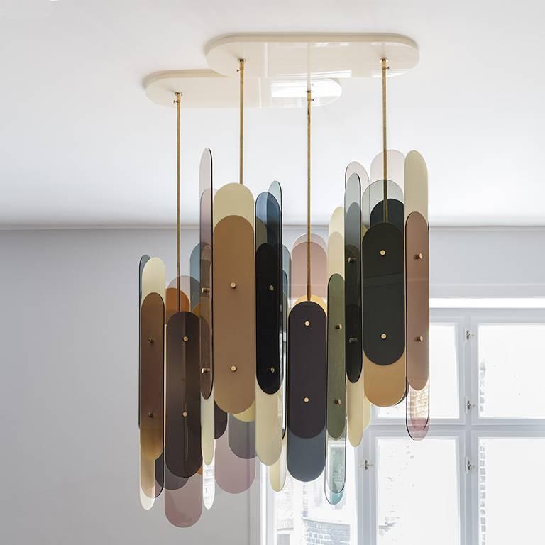 The Stafa chandelier is constructed of four Stafa lights gathered in a plexiglass ceiling plate. The Stafa is a hexagonal construction and each side consists of two sheets of partially overlapping laser cut plexiglass in different colors and