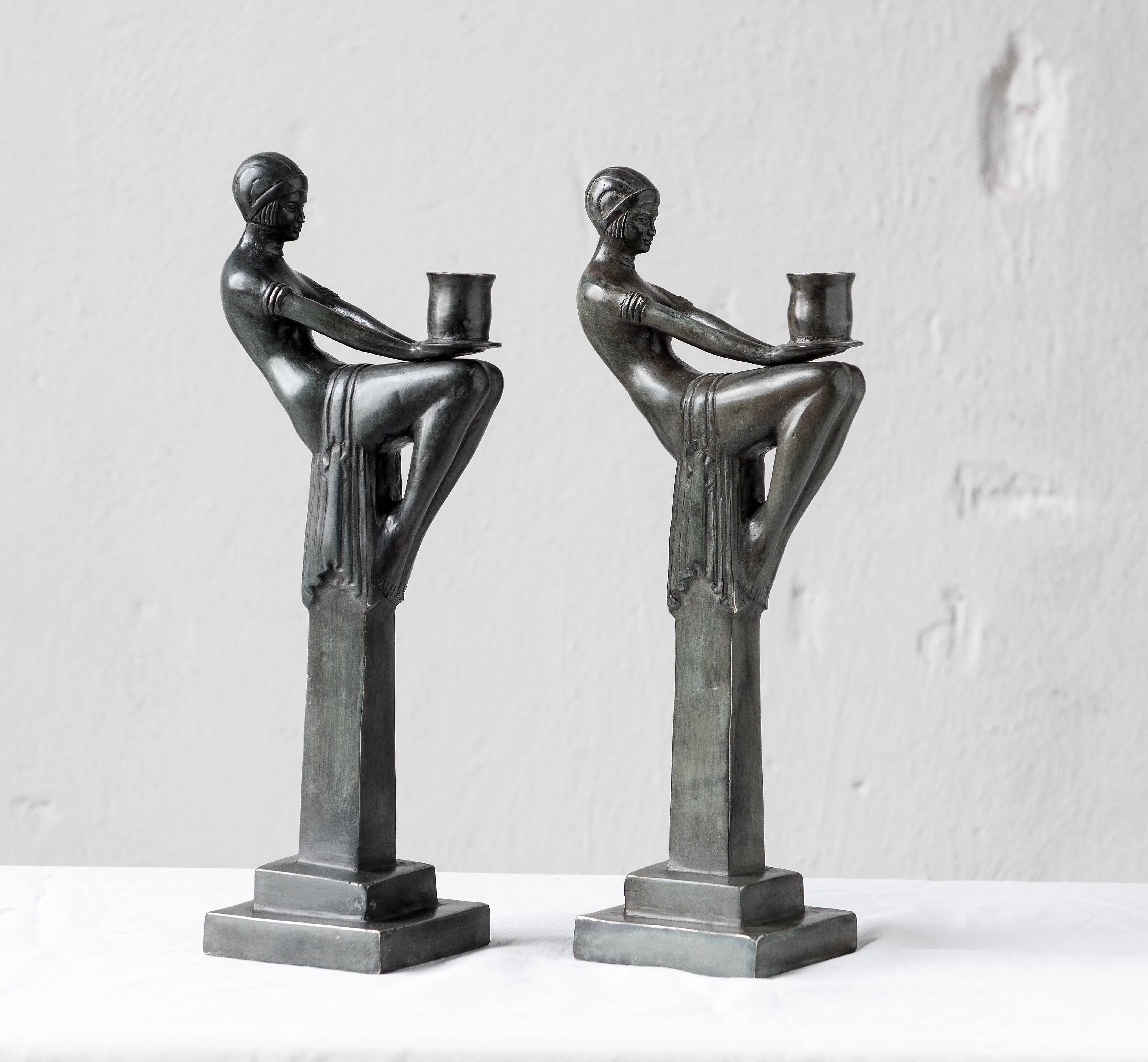Pair of candlesticks in patinated bronze Art Deco style.
 