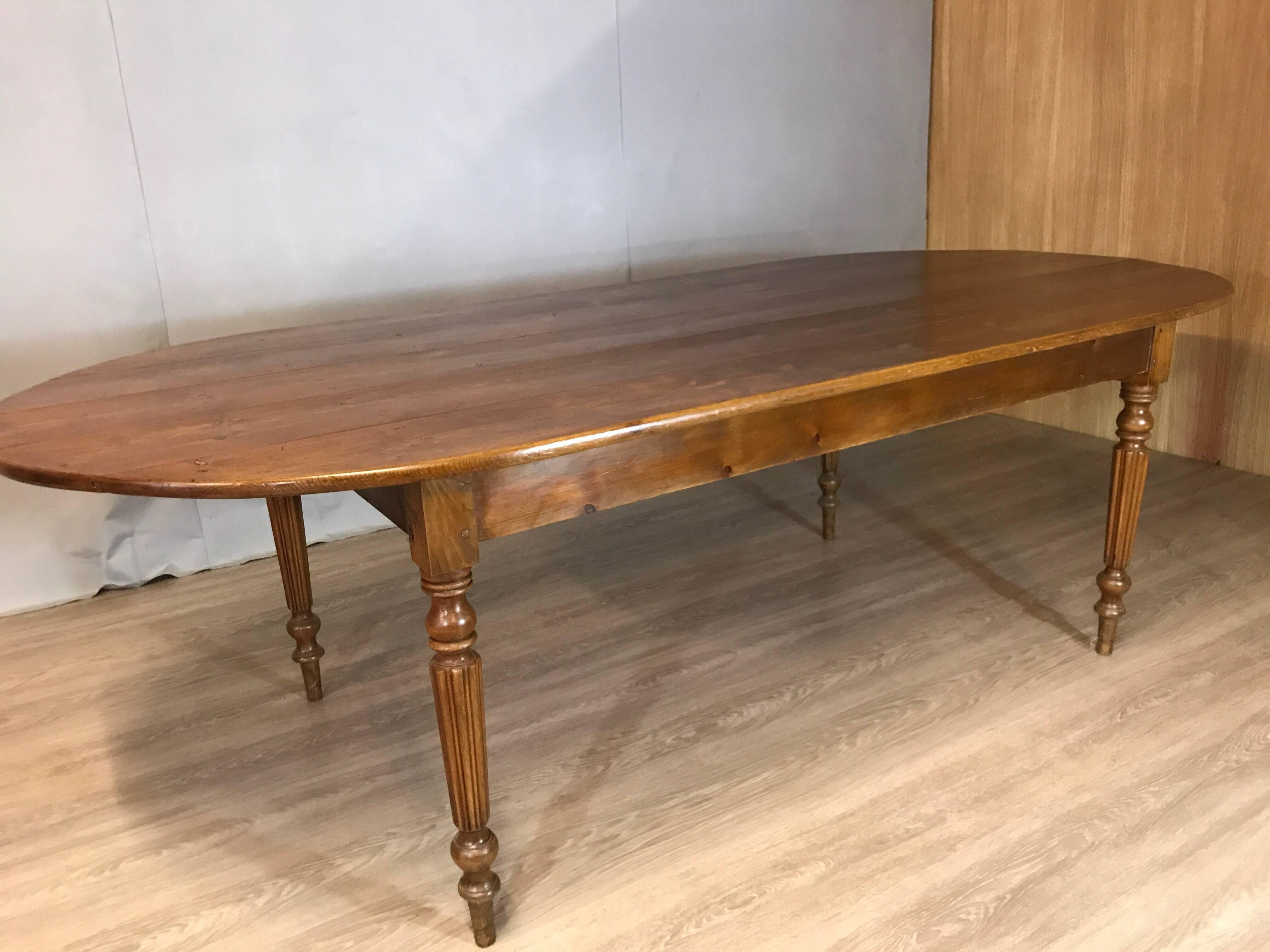 Antique pine table with oval ends and lovely warm beech turned and fluted legs. Wonderful width table and would comfortably seat 8/10 people.