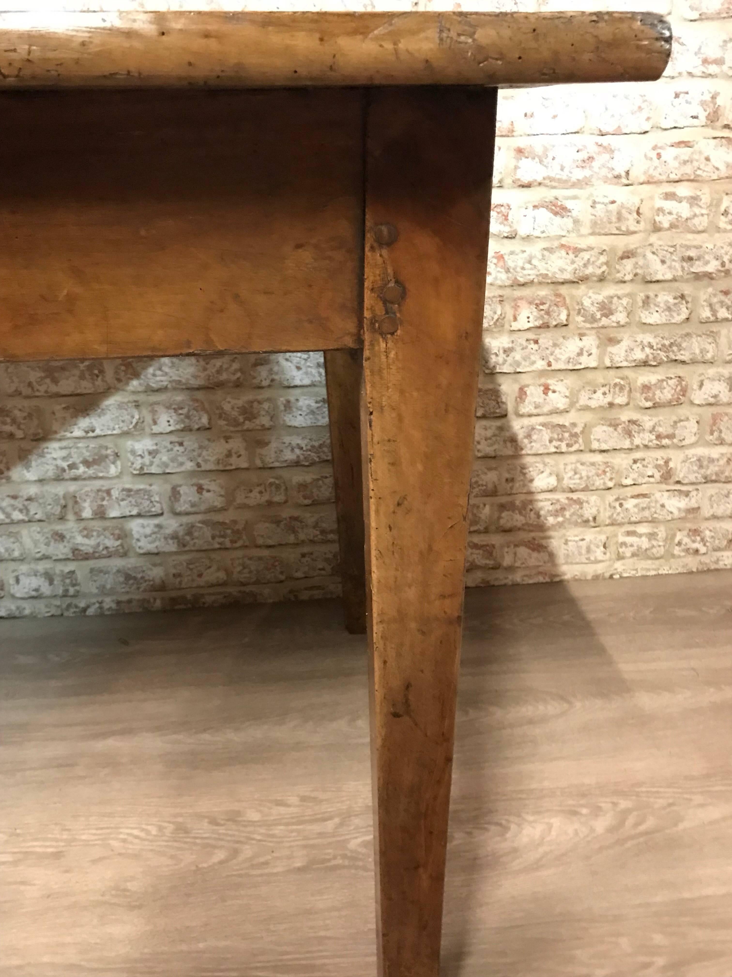 This is a beautiful cherry French Farmhouse table with two drawers. The table sits on four gorgeous tapered legs, lovely medium brown in colour and has a lovely characteristic three plank top.   The table also has a drawer on each side, great for