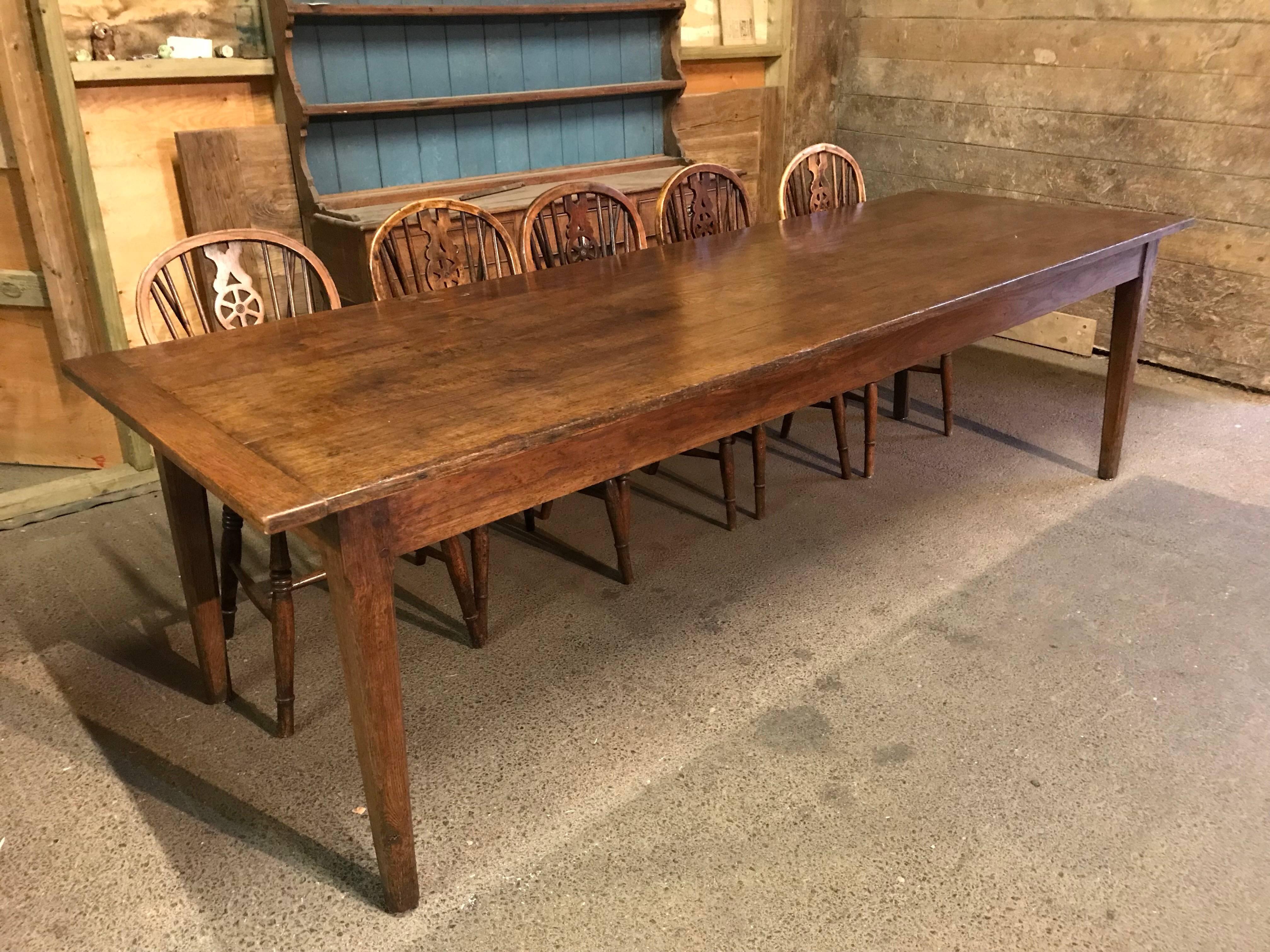 A beautiful chestnut farmhouse table, circa 1840, with gorgeous colour. This 8'4ft table is a comfortable 10/12 seat table. The top has three planks with cleated ends and lovely tapered chamfered legs. Good sturdy table. The color is a little