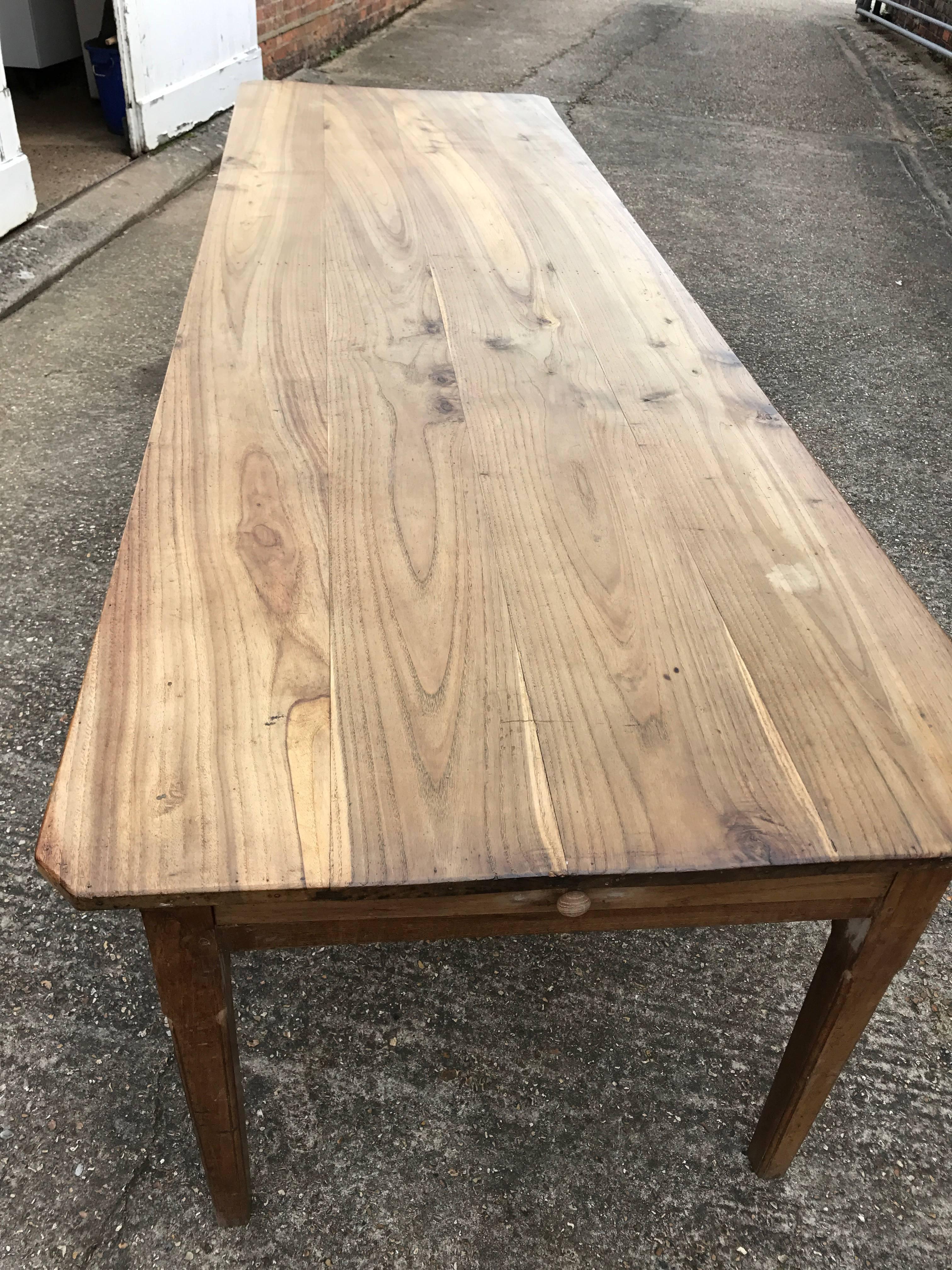 Early 19th century 9' 10 chestnut antique farmhouse table. A very large antique dining table comfortably seating 12 people. This table sits on a very sturdy base with tapered legs and one drawer on the end. The top comprises of a four plank top with