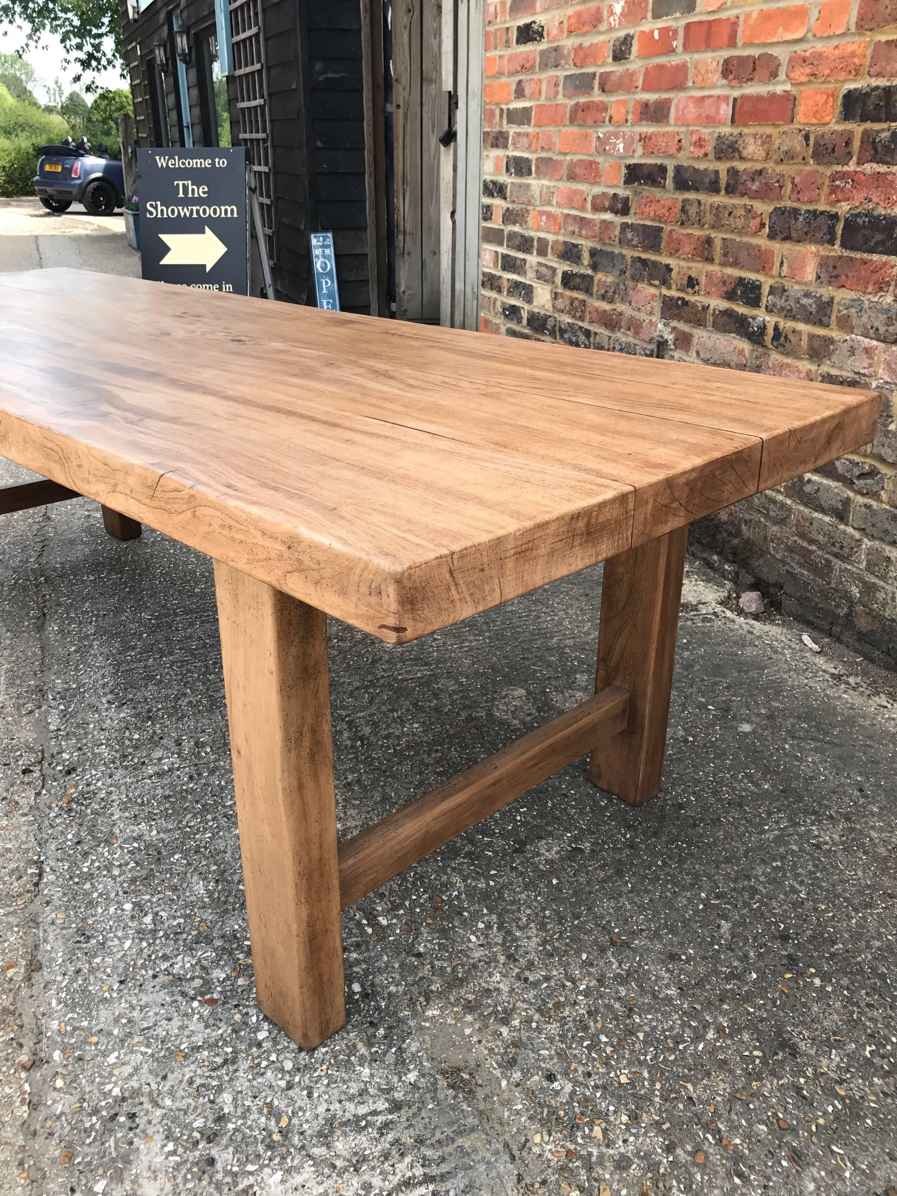 Antique French Normandy table. Wonderful pale colour and patina. Very sturdy table that sits on four square legs supported by an end stretcher with a thick 7cm gorgeous top. Good figuration in the three plank top. This table would seats up to ten