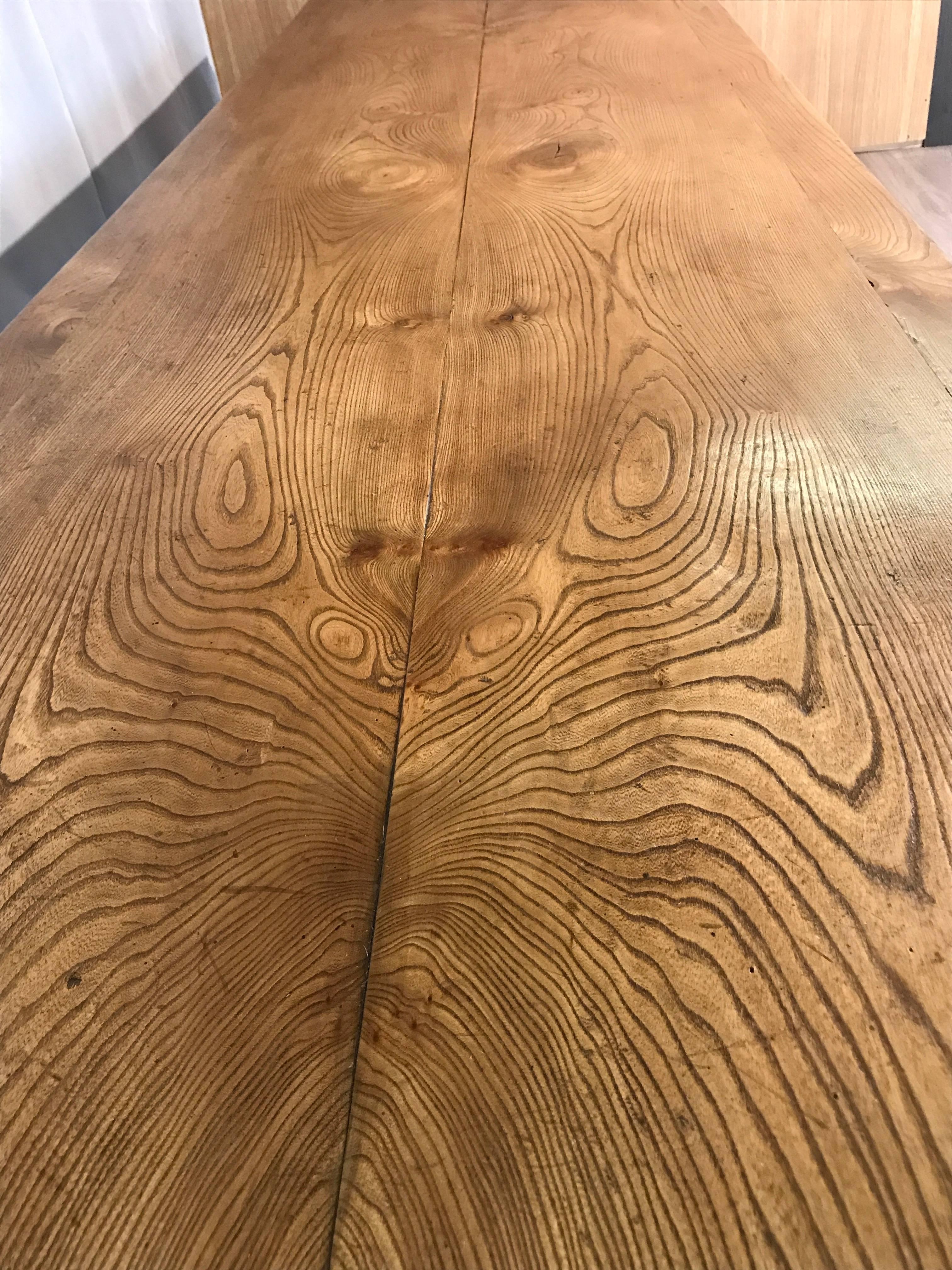 A very large 19th century style French refectory table with a framed two plank elm top. A beautiful mellow color with wonderful movement in the grain. The surface has been textured and lightly distressed to give it a deep patination which will lend