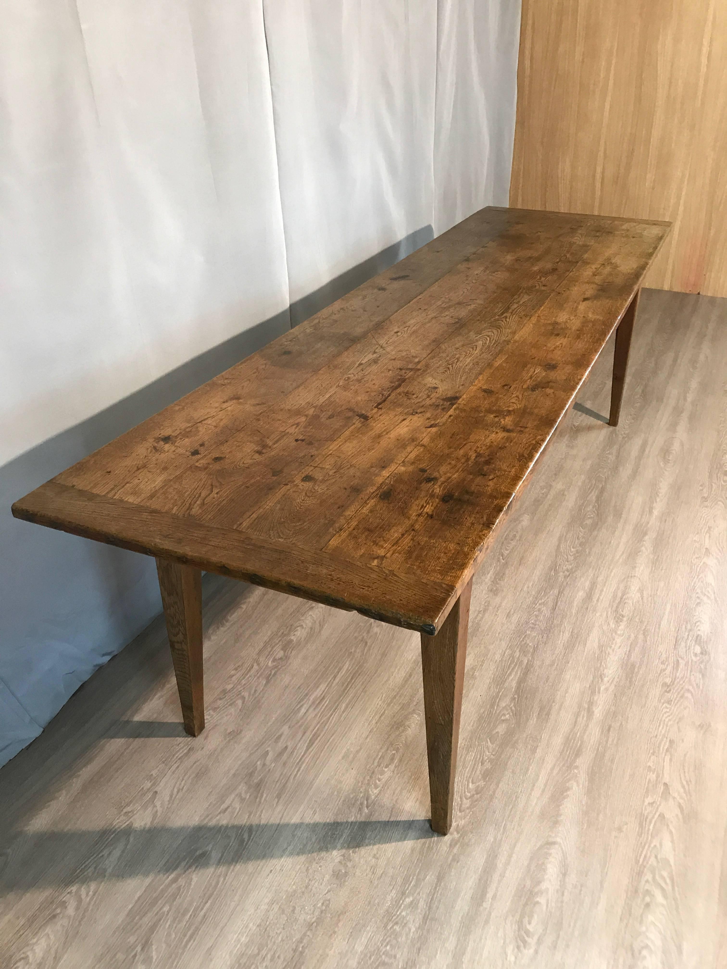 Early 19th century oak serving table with one centre drawer and two sliding panels sits on tapered legs with ample leg room. Both compartments with panels were used for storing the dough bread. This beautiful oak serving table can be used either as