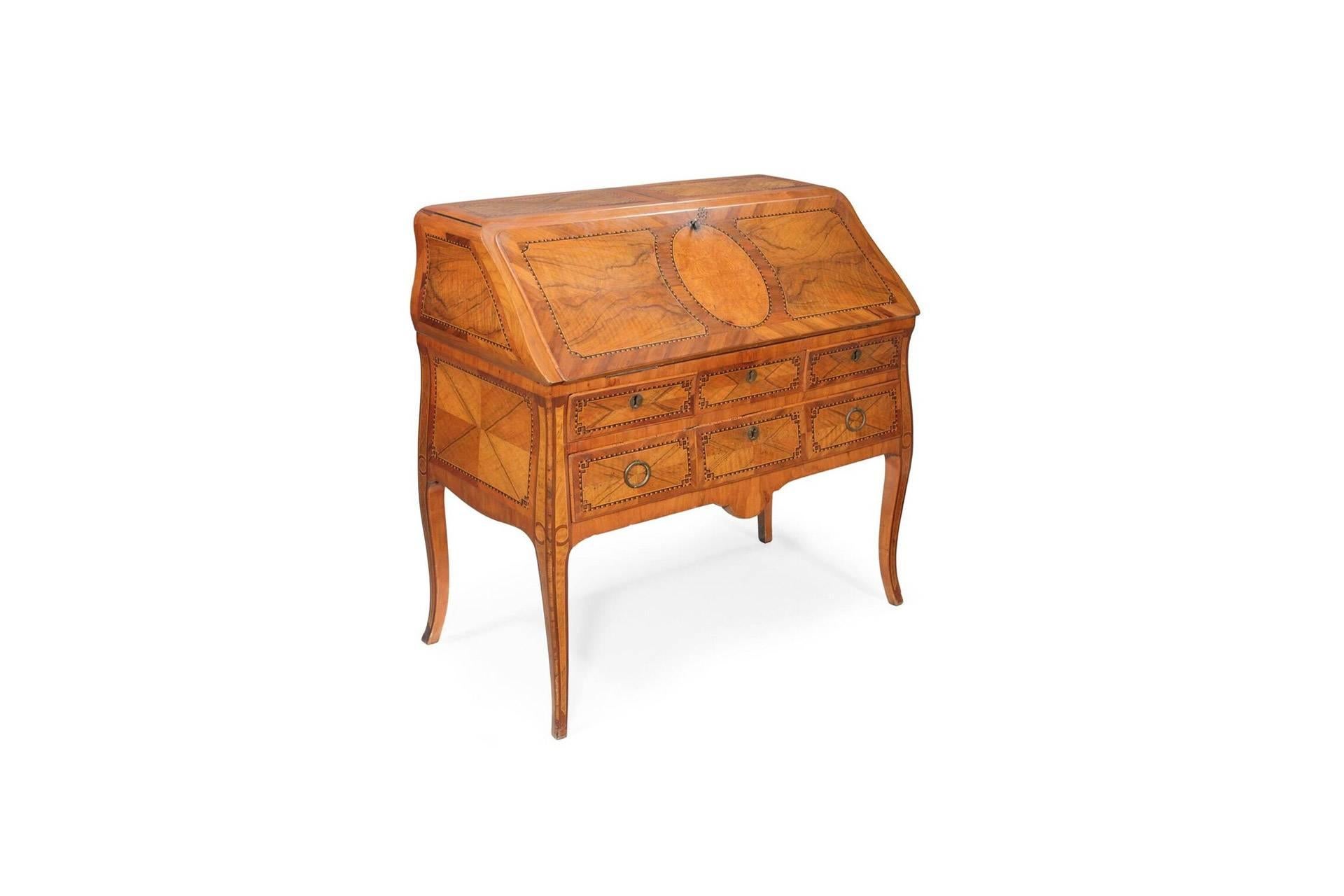 Stunning transition style bureau in walnut, ash and tulipwood. Entirely made with exquisite marquetry details, it has three external drawers and wonderful leather-lined writing top. The interior has five drawers, three sections and a secret
