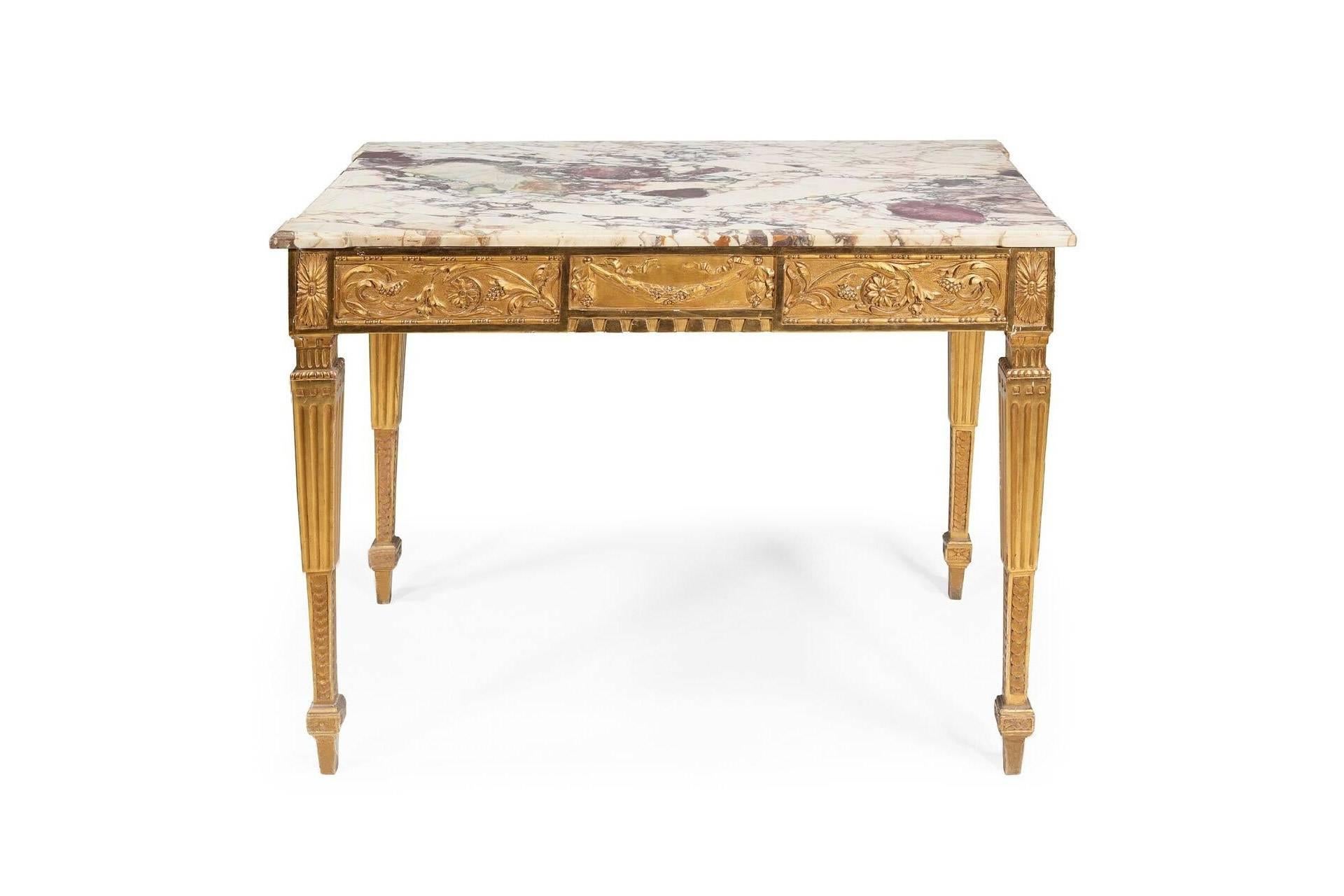 Louis XVI centre table with a beautifully grained marble top and floral motifs in giltwood.

 