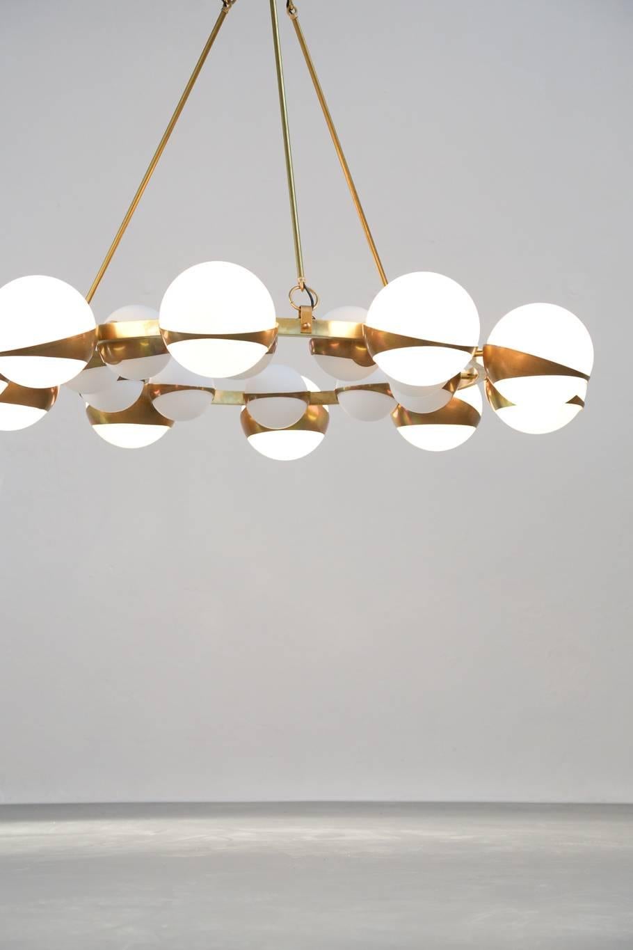 Beautiful chandelier Stilnovo style. Opaline and Brass.
Ten big exterior globe and ten small interior.
    