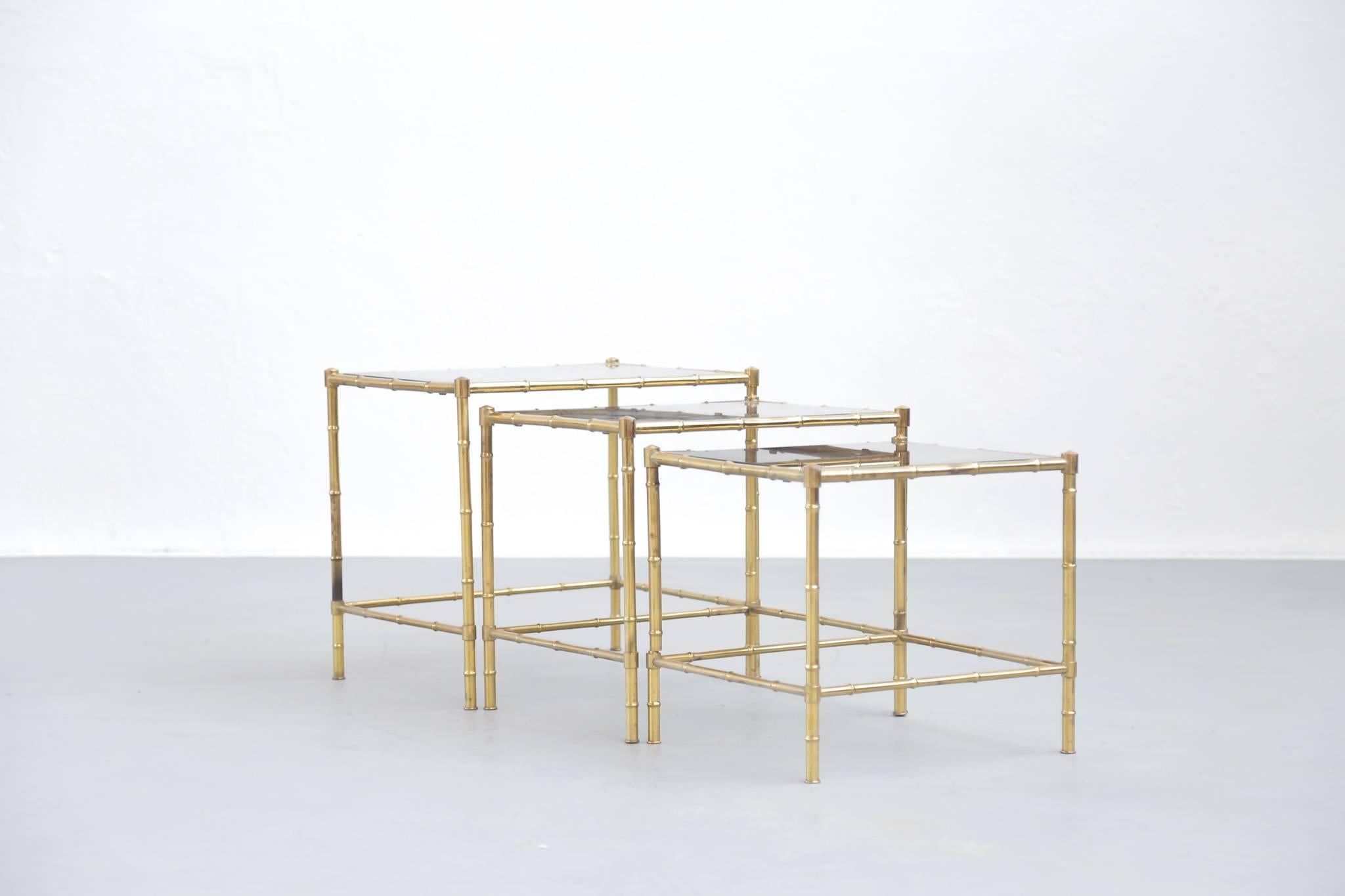 These classic and elegant solid brass nesting coffee tables are made of brass by Maison Baguès.
Faux bamboo frame on casters.