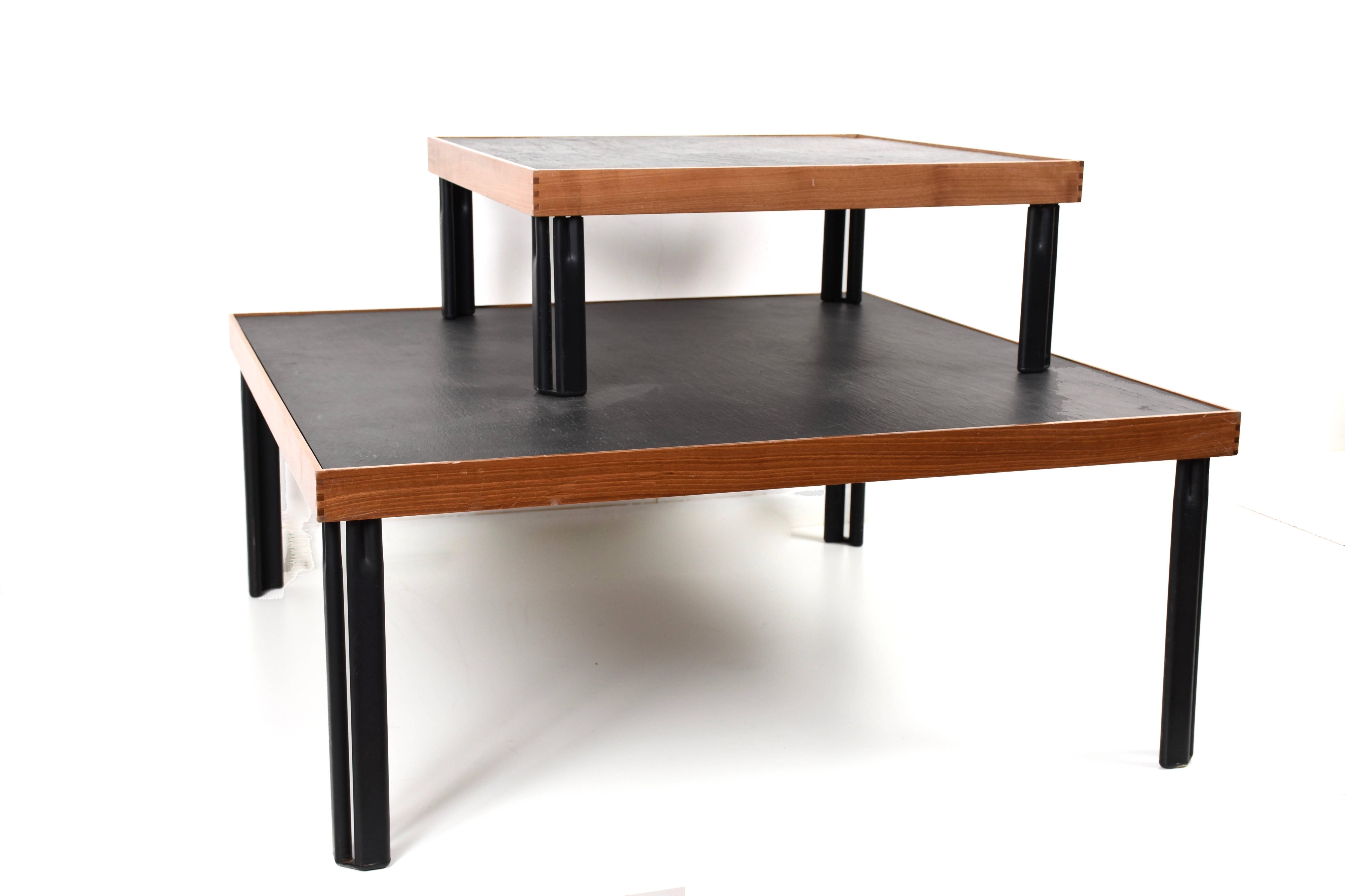 Naviglio. Designed by Piero De Martini for Cassina, Italy, 1980s.

Walnut, slate and lacquered metal.
Large table measures: 85 x 85 x cm 35 H
Small table measures: 57 x 57 x cm 22 H.